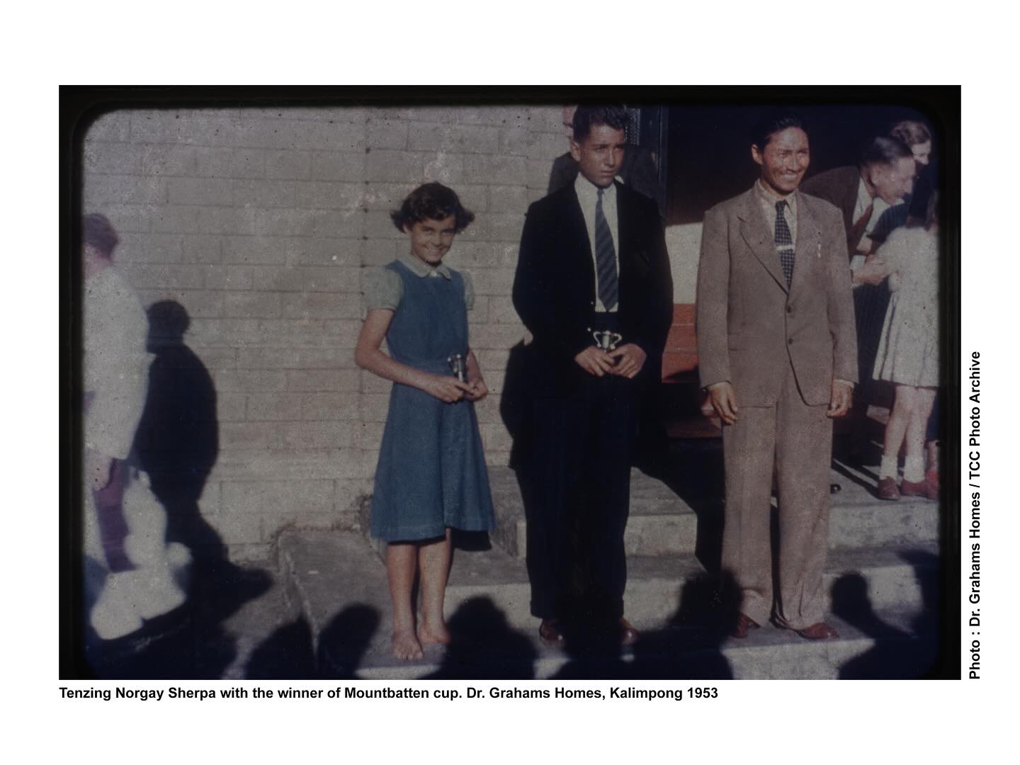Tenzing Norgay Sherpa with the recipients of the Mountbatten Cup, Dr. Graham’s Homes, Kalimpong, 1953.
Photo : Dr. Graham’s Homes / TCC Photo Archive
Today marks 72 years since Tenzing Norgay Sherpa and Edmund Hillary reached the summit of Chomolungma known globally by its colonial name, Mount Everest—and also the 111th birth anniversary of Tenzing Norgay.
Their 1953 ascent was more than a milestone in mountaineering history, it was a moment rooted in the strength and knowledge of Himalayan communities. For generations, Indigenous highlanders have moved through these sacred landscapes with reverence, skill, and resilience. Chomolungma was never a peak to be conquered—it was, and remains, a being to be respected.
Tenzing Norgay was not a subordinate “guide” as colonial accounts often reduced him to. He was a co-summiter, a leader, and a living embodiment of ancestral wisdom passed down through the Sherpa people. And yet, while Edmund Hillary was knighted by the British Crown, Norgay was given the George Medal—a disparity that speaks volumes about the racial and imperial hierarchies still embedded in how the world measures achievement.
Even after India’s independence, the legacy of empire continued through British-named trophies like the Mountbatten Cup, Herlihy Cup, and Governor’s Cup symbols of a colonial system that often erased or sidelined Indigenous contributions to mountaineering and exploration.
As we remember this historic ascent, let us also honor the countless mountain porters, guides, and Sherpa families whose labor, care, and courage made it possible. The legacy of Chomolungma does not belong solely to those who plant flags on its peak it belongs to all those whose lives, stories, and spirits are intertwined with the mountain itself.