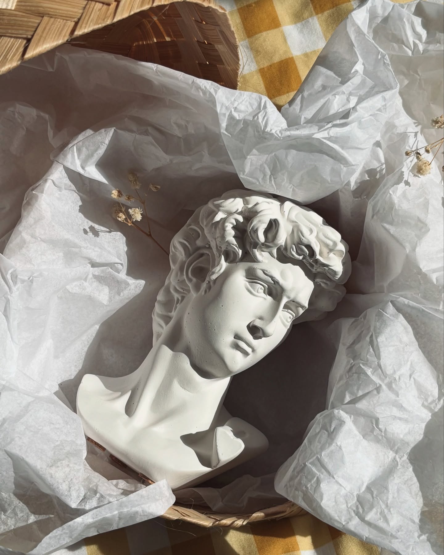 This mini David statue is handmade from a concrete-like material, giving it a beautiful stone texture and sculptural feel.