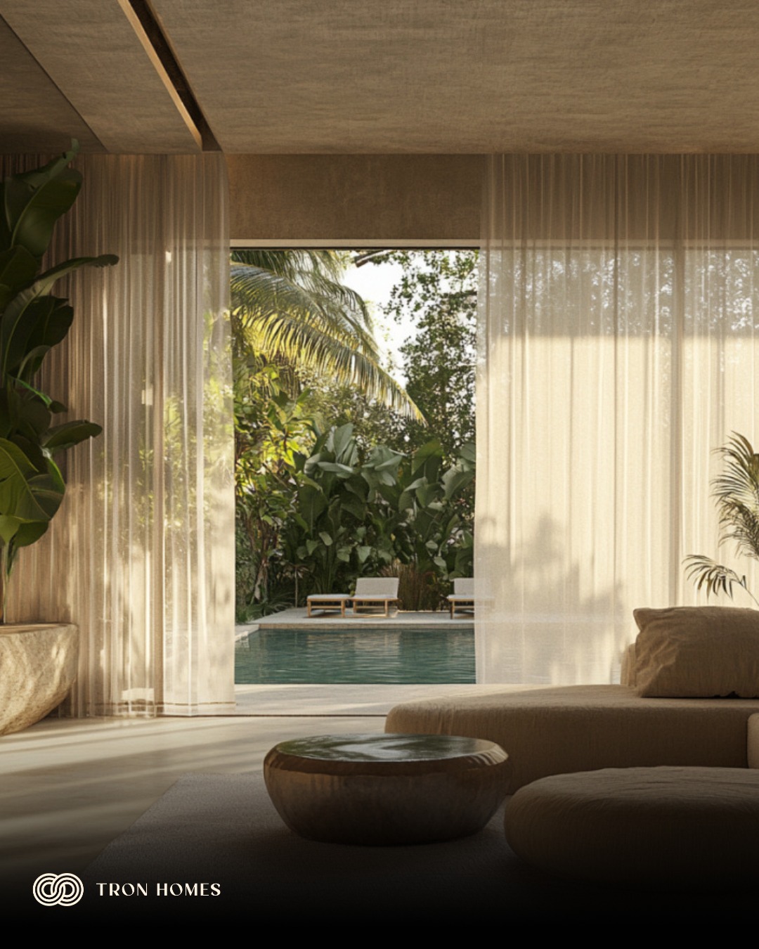 Can softness be designed?
We asked ourselves this question and then set out to find an answer. The quest led us to this concept, where we explored how interior design can evoke calm regardless of the physical layout of the room.
- Neutral tones keep the eye relaxed.
- Low, rounded furniture softens the visual rhythm. No bright contrast. No hard edges.
- Natural stone, sheer drapery, and warm light work together to bring a touch of a cocoon-like feel to the room.
If you are planning a room like this in your home, we would love to help.
#TronHomes #MinimalArchitecture #architecturalvisualization #modernarchitecturedesign #ModernLuxury #softhome #interiordesignideas