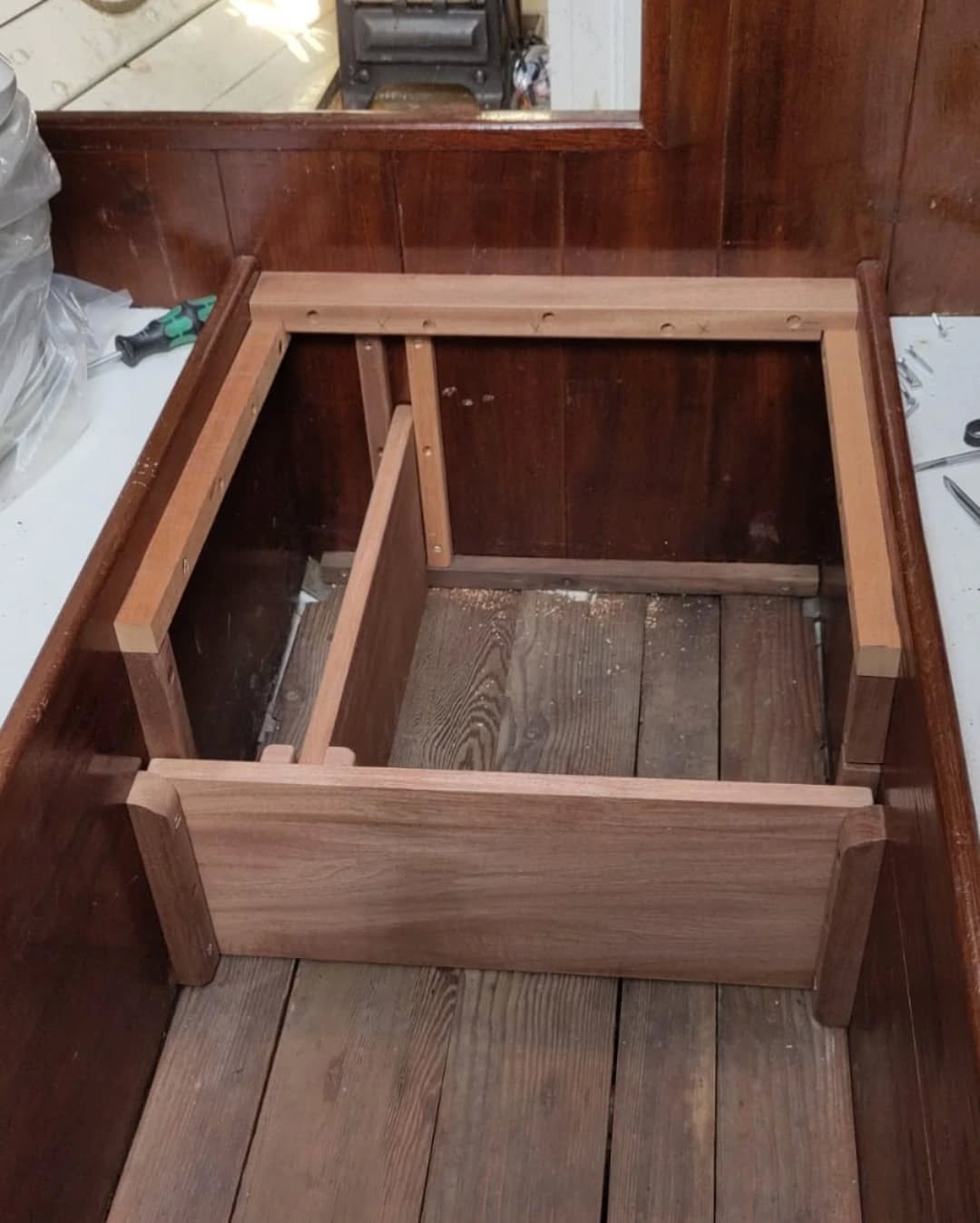 This little boat didn't have room to fit a toilet so we've made a shiny box for a cassette camping loo instead!