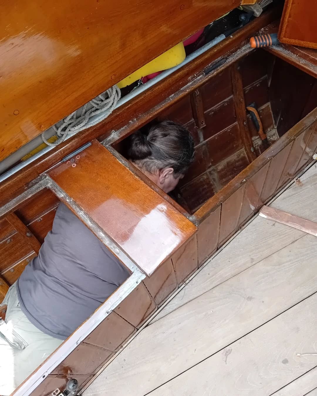 Lucy carrying out timber repairs. A bit cosy!