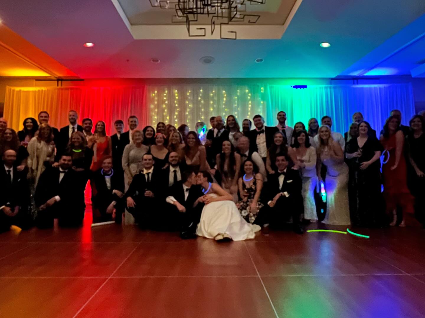 Group photo break! I noticed something super cool at the top of the photo, can you see it? (Hint: initials)
The couple booked my impact package with full room uplighting and it really made the room pop. Congrats again, Courtney & Jake! 🎉🎵