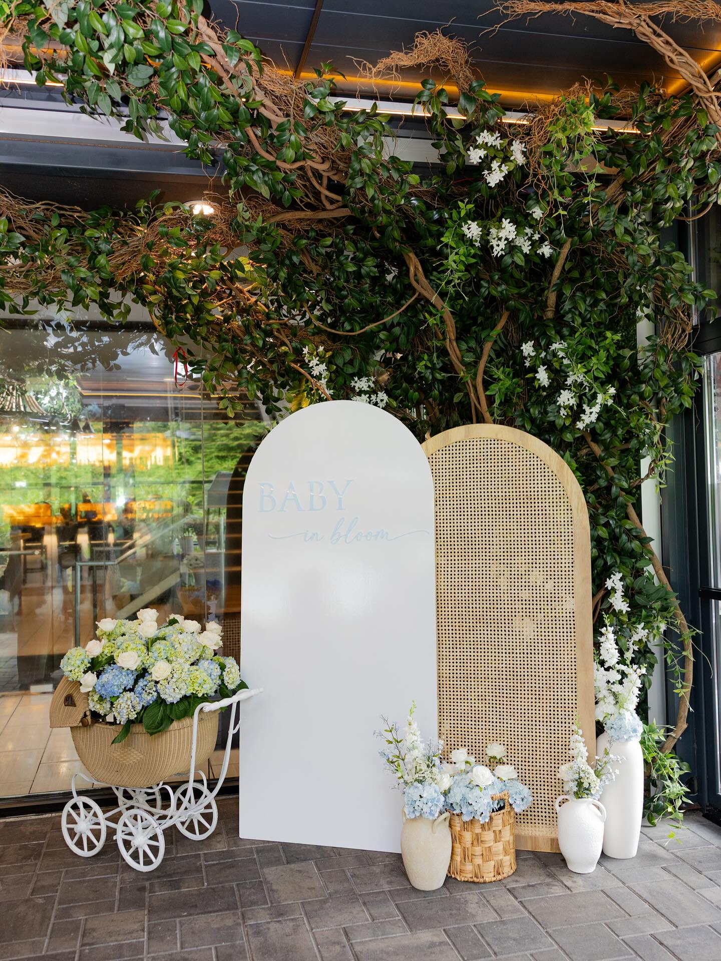 baby in bloom baby shower inspo! Had so much fun creating this “Baby in Bloom” acrylic back drop, welcome sign, and our very own handmade flower cart for the beautiful mama to be! 💐🩵 Rattan wall: @thebackdropbar_ Baby carriage: @babygotbackdropsny #babyshower #babyinbloom #mamatobe