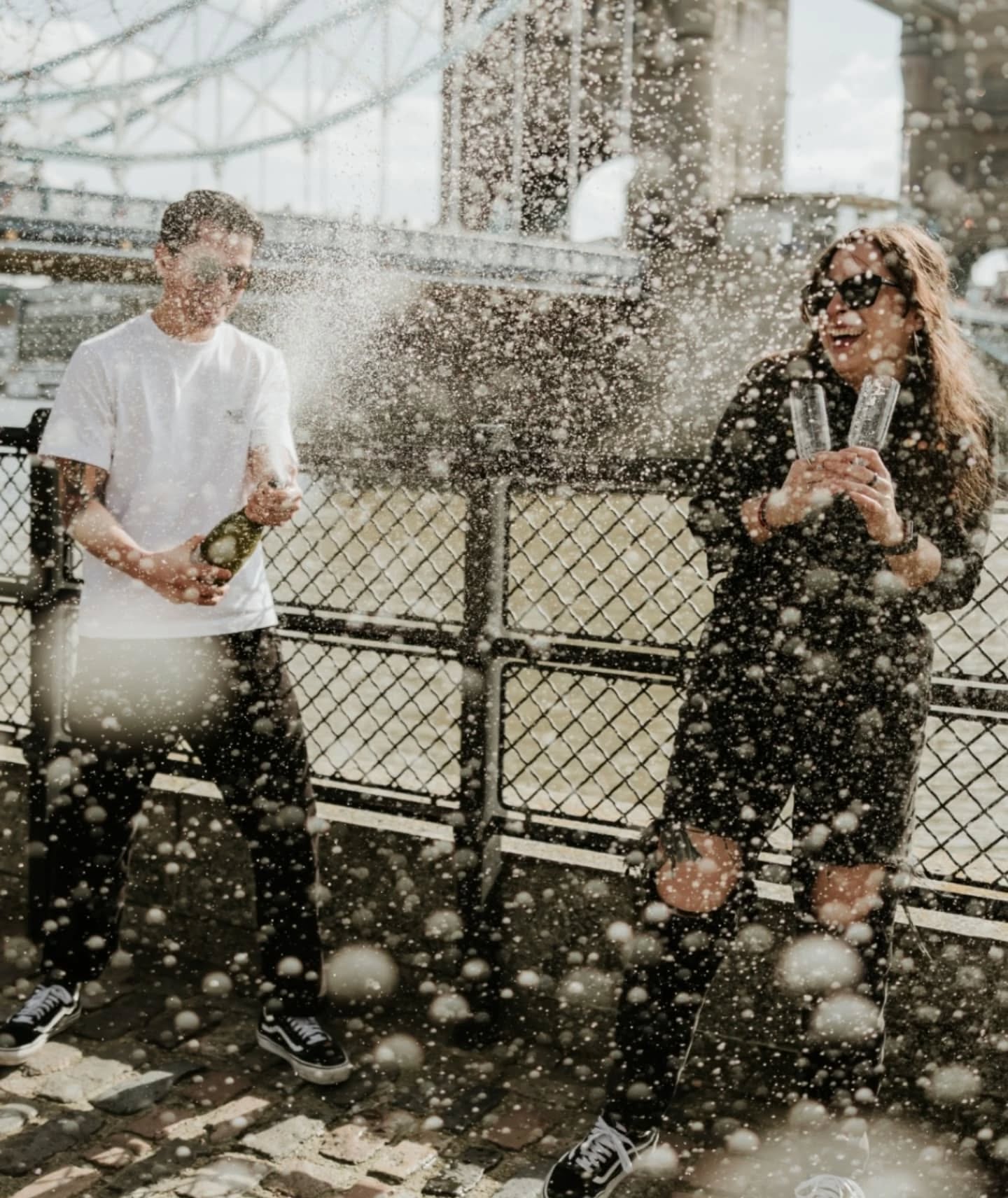 A very London proposal 💍 If you've ever thought about hiring a photographer for popping the question read on for how to absolutely smash it... Miguel booked me before his visit to London and knew that whatever the plan, he wanted to ask Andrea to marry him in front of Tower Bridge with her family close by, bubbles at the ready to celebrate. Me hiding out of sight was not going to be an option in such a busy location as people would 100% have blocked my view, so he surprised Andrea with a couple's photoshoot. We spent the morning together honing in on their vibes with a visit to Rough Trade Records and stopping for their tradition of sharing one pint between them, then hopped on the underground to "finish up in a classic London spot". We took couple photos in front of the bridge while Miguel text his family to make their way from a coffee shop and as soon as he spotted them it was go! I cannot explain what a privilege it was to be part of this event from the start and to have Miguel trust me with his plan. To top it off there was no stress of hiding out of sight, making sure I was in the right spot or people getting in my way. I just got to be there and hang out with them before the next chapter in their lives was about to start. What an absolute dream! Congratulations Miguel & Andrea 🍾 what a perfect London love story.