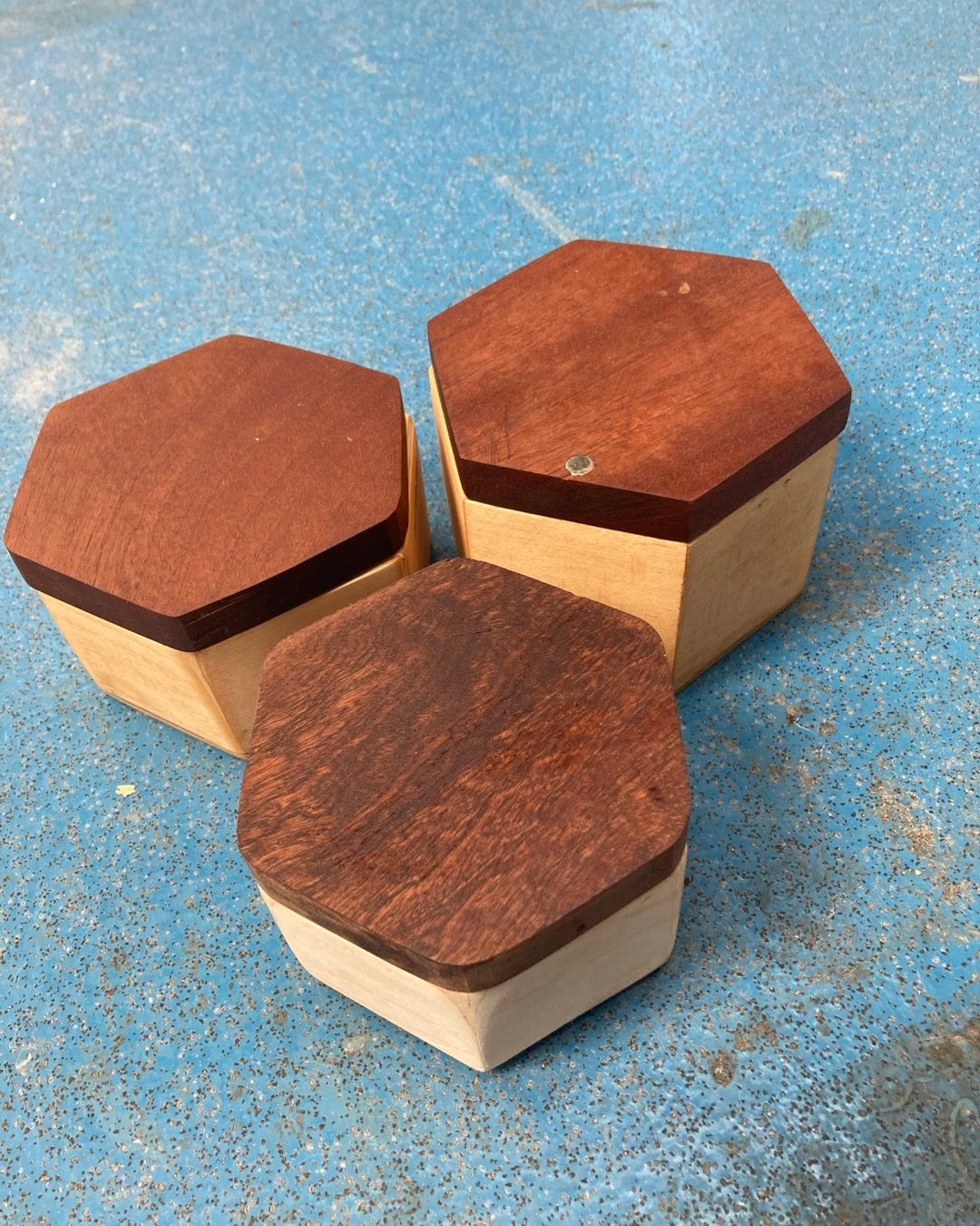 Hexagonal boxes with hardwood tops secured with magnets