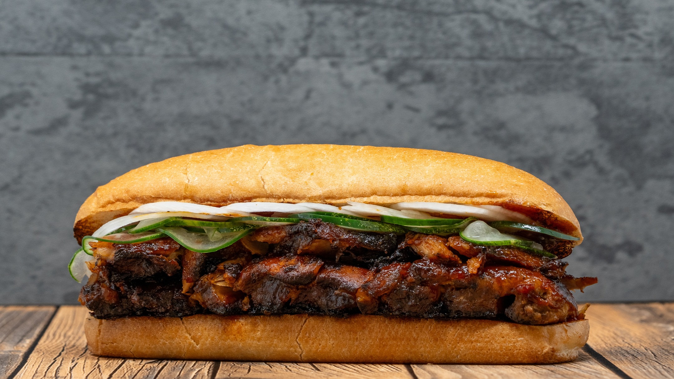 Once called the "McRib" before we got a cease and desist email; such an honour. The MR. RIB is a half rack of Ontario farm fresh baby back pork ribs. Smoked, deboned, grilled and stacked on a freshly toasted italian bun. It's then finished with thinly sliced vidalia onion, sliced S&S pickles and S&S BBQ sauce.
This is our version, not some clown in big red shoes. 🤡