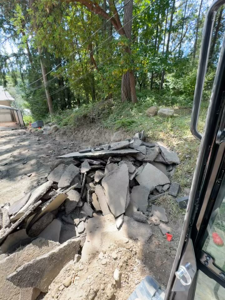 Ripping up the ashfault driveway so the ground is permeable after the new garage is built. #rules #regulations
