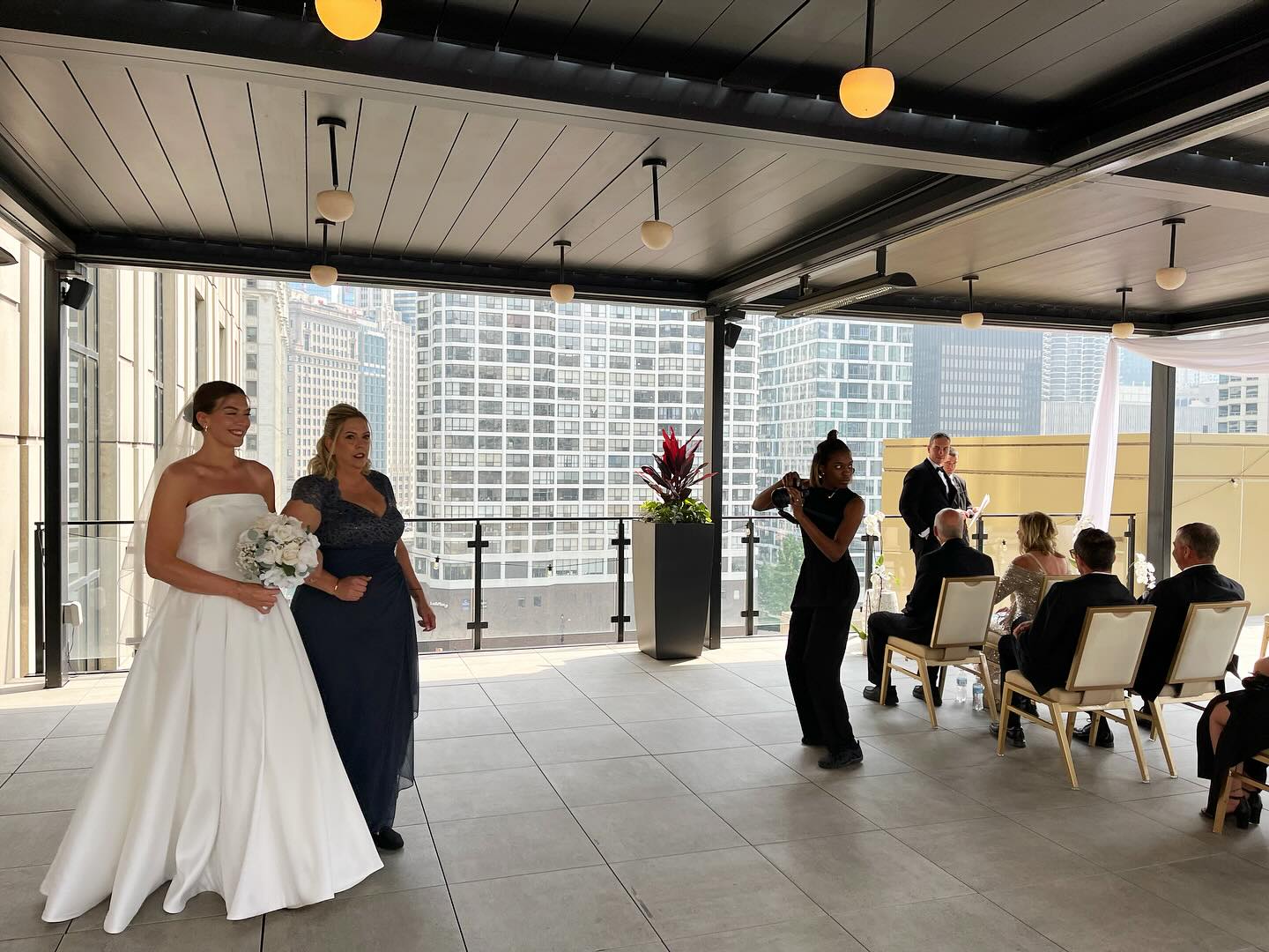 This ceremony had such nice views of downtown! Check out their doggy running to them after the recessional. 🙏🎉👏