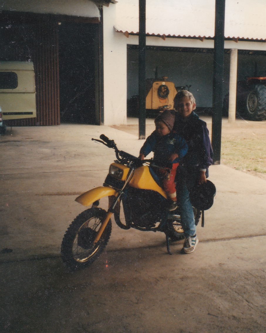 I was nine years old when I got my first motorbike.
A little yellow scrambler with no speedometer, no rules, and definitely no helmet.
My nephew was two.
I’d sit him up front—small hands gripping the bars like he belonged there.
His sister, six years old, would climb on the back, arms wrapped tight around my waist.
And off we’d go—three kids with no supervision, no fear, and no idea how insane it probably looked from the outside.
We rode everywhere.
Across dirt tracks and bush trails, through the tall grass and open fields of a game farm full of wild animals.
Kudu, warthog, giraffe. We learned to live around them. Respect them. Sometimes race them.
There were no helmets. No GPS.
Only instinct, dust, and the throttle.
We didn’t know the word “risk.” We just knew freedom.
And we never had a problem.
Not once.
It’s wild to think how different that world was from the one kids grow up in now.
A world wrapped in caution tape and cotton wool, where everything is padded and scheduled and approved.
But that farm raised something different in me.
It taught me to trust myself.
To lead, even when I didn’t know the way.
To carry others.
To move forward with presence, not permission.
It wasn’t safe.
But it was real.
And real is what built me.
#FirstBike #FarmLifeRoots #WildAndFree #MotorbikeMemories #BushveldChildhood #AdventureRaisedMe #FreedomIsntSafe #TheWayWeWere
#ThrowbackAdventure
#YoungAndWild
#ChildhoodUnfiltered
#NoRulesJustRide
#OldSchoolFreedom
#BackInTheDayVibes
#AdventureInMyVeins
#RaisedByTheRide
#MotorbikeKid
#BushveldDays #DirtBikeLife
#FarmBike
#RideWithHeart
#MotorcycleJourney
#TwoWheelsAndFreedom
#BikeLifeAdventures
#RideToRemember
#ThrottleTherapy
#MotorbikeStories
#LifeOnTwoWheels