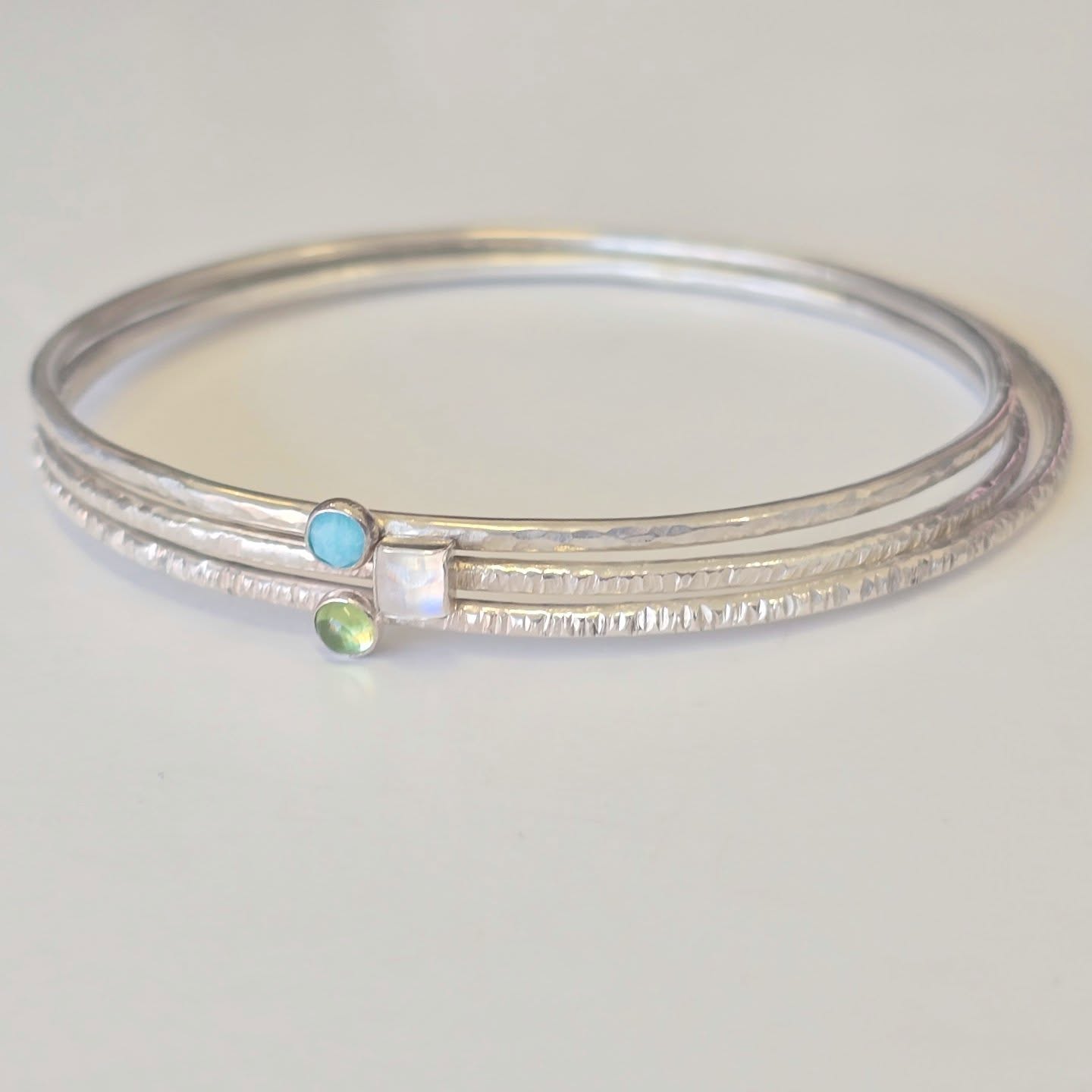 Birthstone stacking bangles, they look so pretty together. Peridot, Moonstone and Turquoise.
.
.
.
#bangles #birthstonebangle #armcandy #bangleset #handmadejerseyci #handmadejewelleryuk #personalisedjewellery #mombracelet