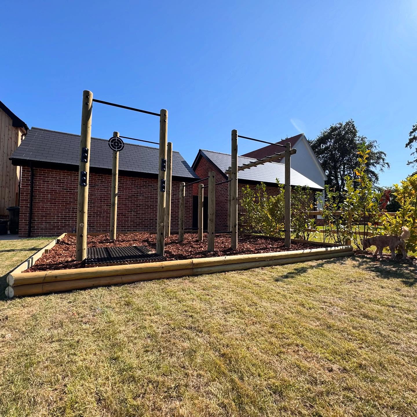 Amazing installation of this multi-station outdoor gym with full bark surface. Pull up bars, dip station, monkey bars, boxing bag bracket, wall ball target and lifting station. The full experience. #pullups #monkeybars #dipstation #outdoorgym #gardengym
