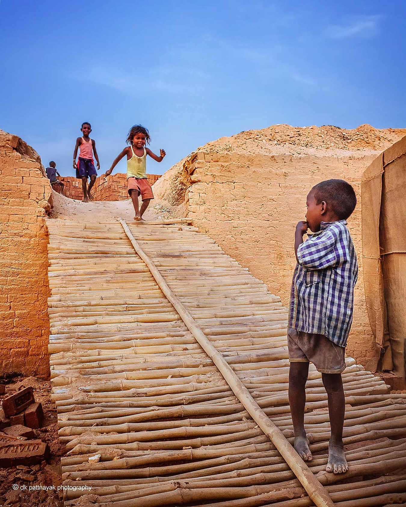 At the brick kilns of Odisha, shot by (@dkpattnayak), childhood runs on a different clock. While their parents toiled under the sun, these kids found laughter and games in the very dust that built their world.
Here, often school bags are swapped for sacks of clay, play breaks for work shifts. For many kids here, growing up begins too soon.
And with each passing year, the heat rises. Climate change isn’t some far-off worry-it’s already shaping how long they can work, how often they fall sick, how harsh their world becomes.
However, childhood is free of these worries. The world’s a playground, and joy doesn’t need any settings.
#theimpactsociety #culture #childhood #tradition #labourinindia #brickkilns #brickfactory #peopleofindia #brickfactoryofindia #photographer #storyteller #documentary #visualstorytelling