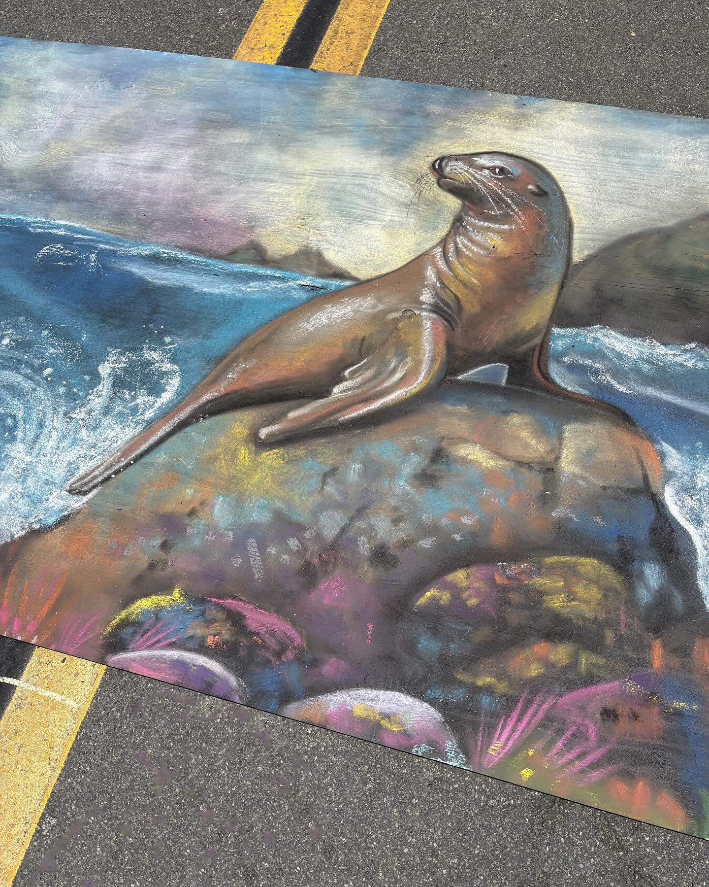 Got to chalk down the road from our home at @carlsbadvillage Art in the Village last weekend! This piece is special for a few reasons: 1. I used an AR headset to trace my image onto the surface for the first time instead of using a pounce. 2. This was the first piece my toddler helped me with substantially! They did the sky and part of the ocean! 3. Helping me sparked their interest in chalk and we’ve done a few small pieces at our home this week. I am a proud momma!
I know y’all are gonna ask, so the chalk was done on a piece of plywood that was painted with one coat of chalkboard paint. The plywood was unfinished which I don’t recommend as it gives splinters 🤕 You can see the wood texture and the indentations in the art if you look closely!
Thank you to @fuseevents and the @artwalksd crew for having me! I’m looking forward to the Bella Vita festival they’re hosting in Little Italy, SD, this fall!
#SanDiegoArtist #ChalkArtist #ChalkArt #SDChalkArtist #ChalkboardArtist