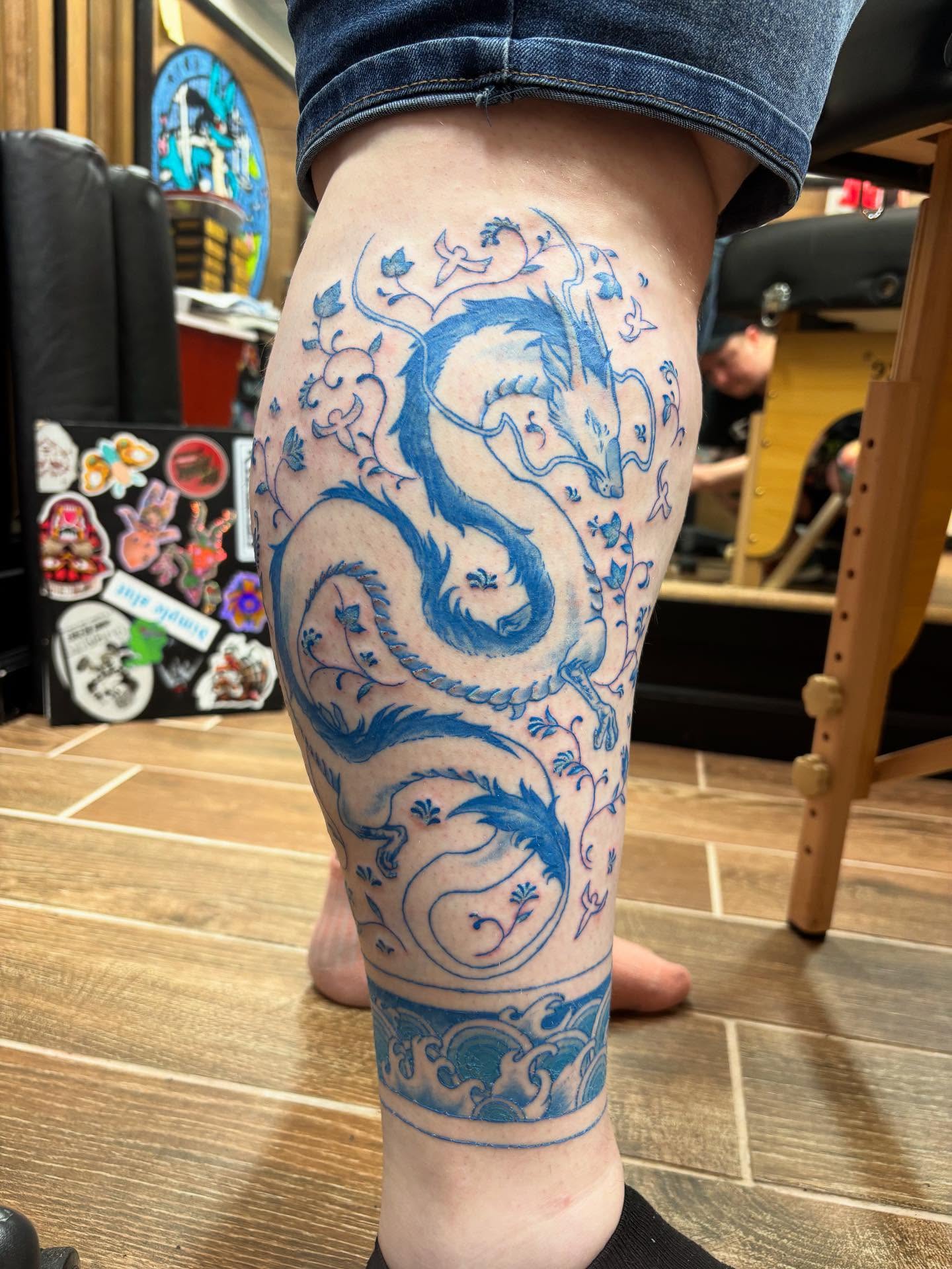 Finished this portion of a blue-only porcelain-style ghibli lower leg sleeve (say that five times fast…) I had lots of fun with this! Excuse the ankle band, it’s healing from a previous session in these pics. Haku linework also fully healed. 🐉 #tattoo #ghibli #ghiblitattoo #spiritedaway #haku #hakutattoo #porcelaintattoo #queertattooartist