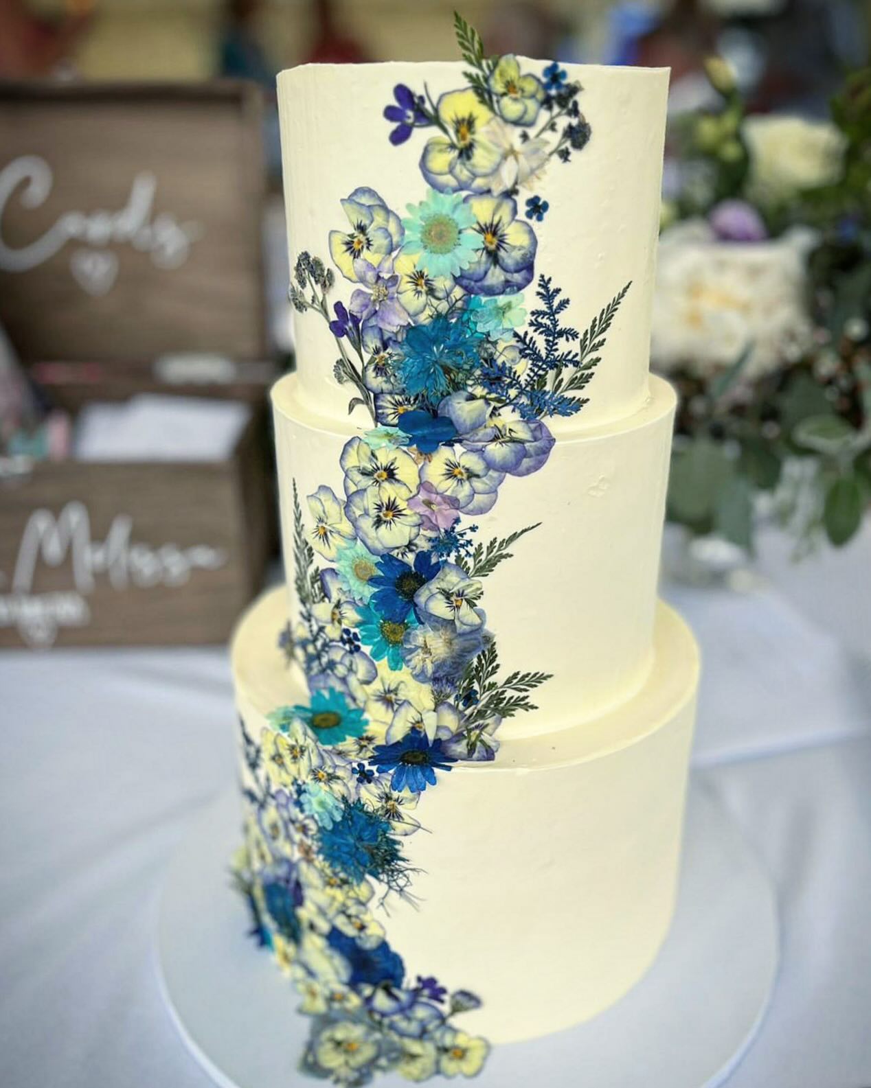 A beautiful three tier pastel blue shades in pressed flowers.
#weddingcake #marthahollis