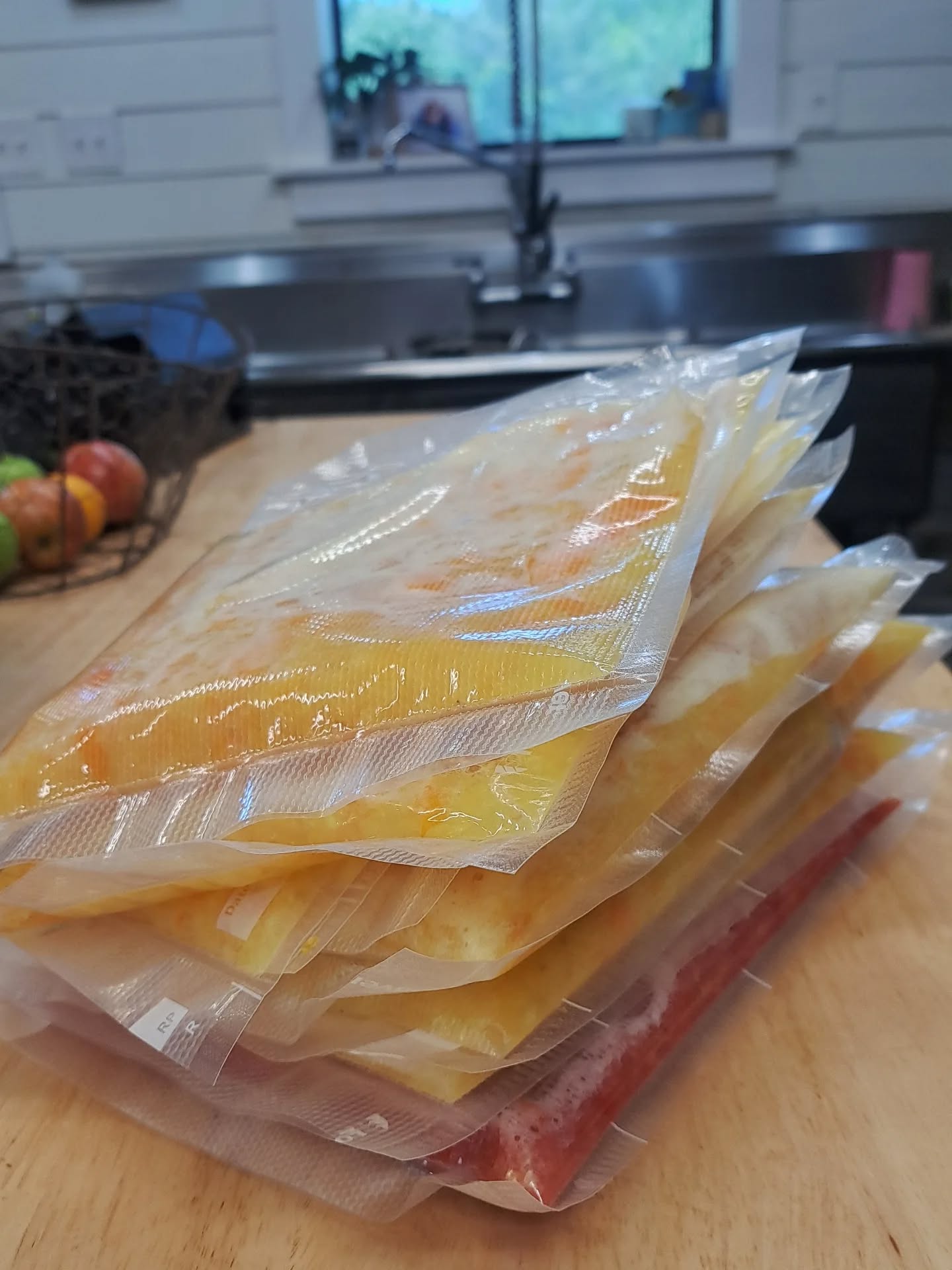 I seriously hate canning extra produce... it heats up the kitchen, and the jars take up so much space. We live in a little barndo, and have very limited shelf space. Instead, I freeze as much as I can! This is 9lb chopped tomatoes, ready for the freezer. I'll use them throughout the year in place of canned diced tomatoes. I just wash and core them, then chop them in my food processor. I seal them with my vacuum sealer, and lay them flat in the freezer. 🍅