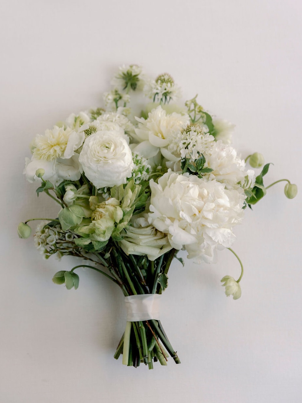 A timeless elegance design, featuring peonies, ranunculus, and hellebores. Beautiful flat lays by @matthewhanlon .