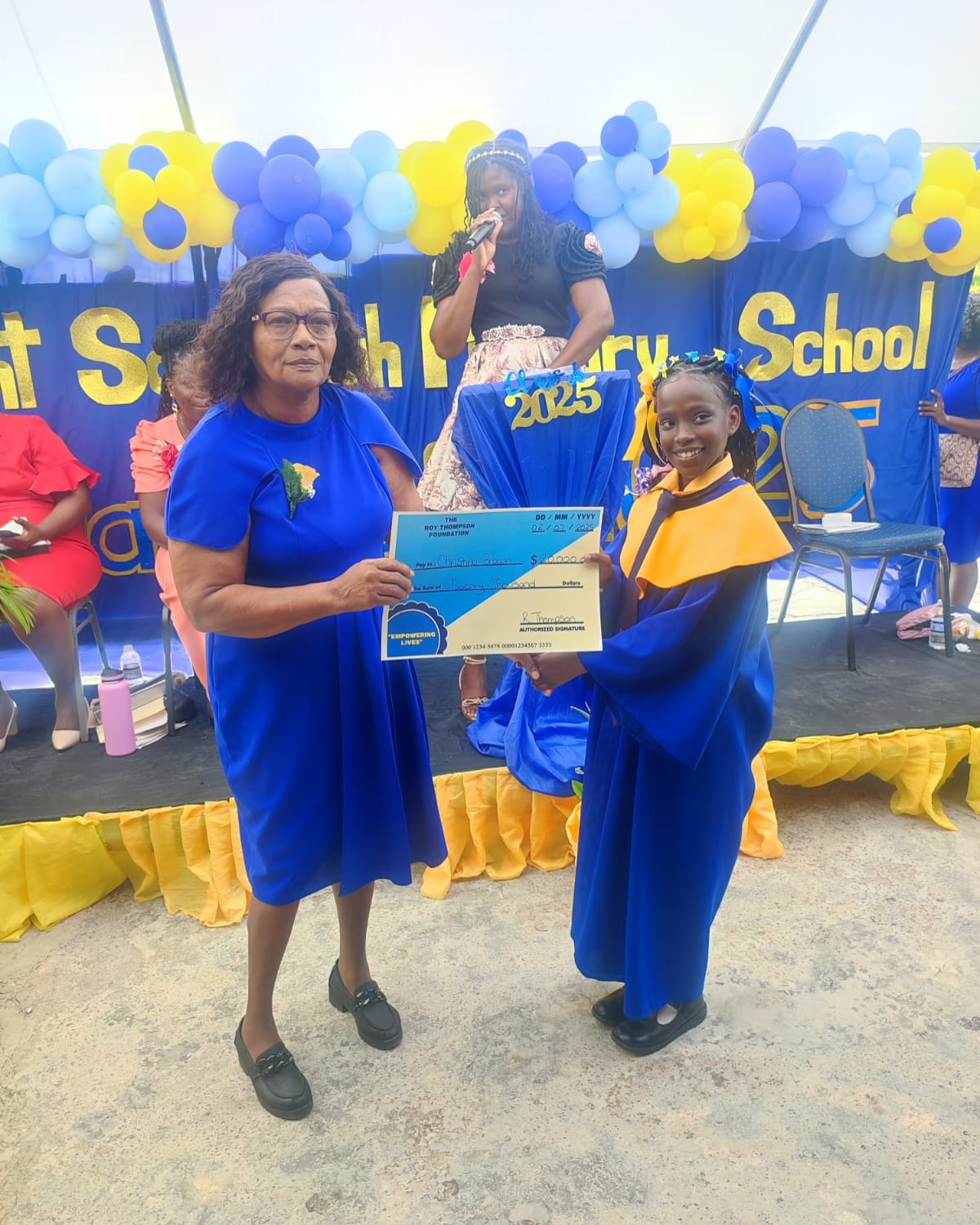 Roy Thompson Foundation presenting the Burnt Savannah Primary School Top Male and Female Academic Achievement awardees with the Tuition Scholarship.