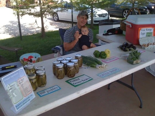 Throwback to maybe our very first farmers market in Louisiana. Look how young Farmer B and our oldest daughter were. And look how little we had on our table. 😂 we’ve come a long way! Swipe to see our spread at the farmers market these days. #sliceofheavenfarm