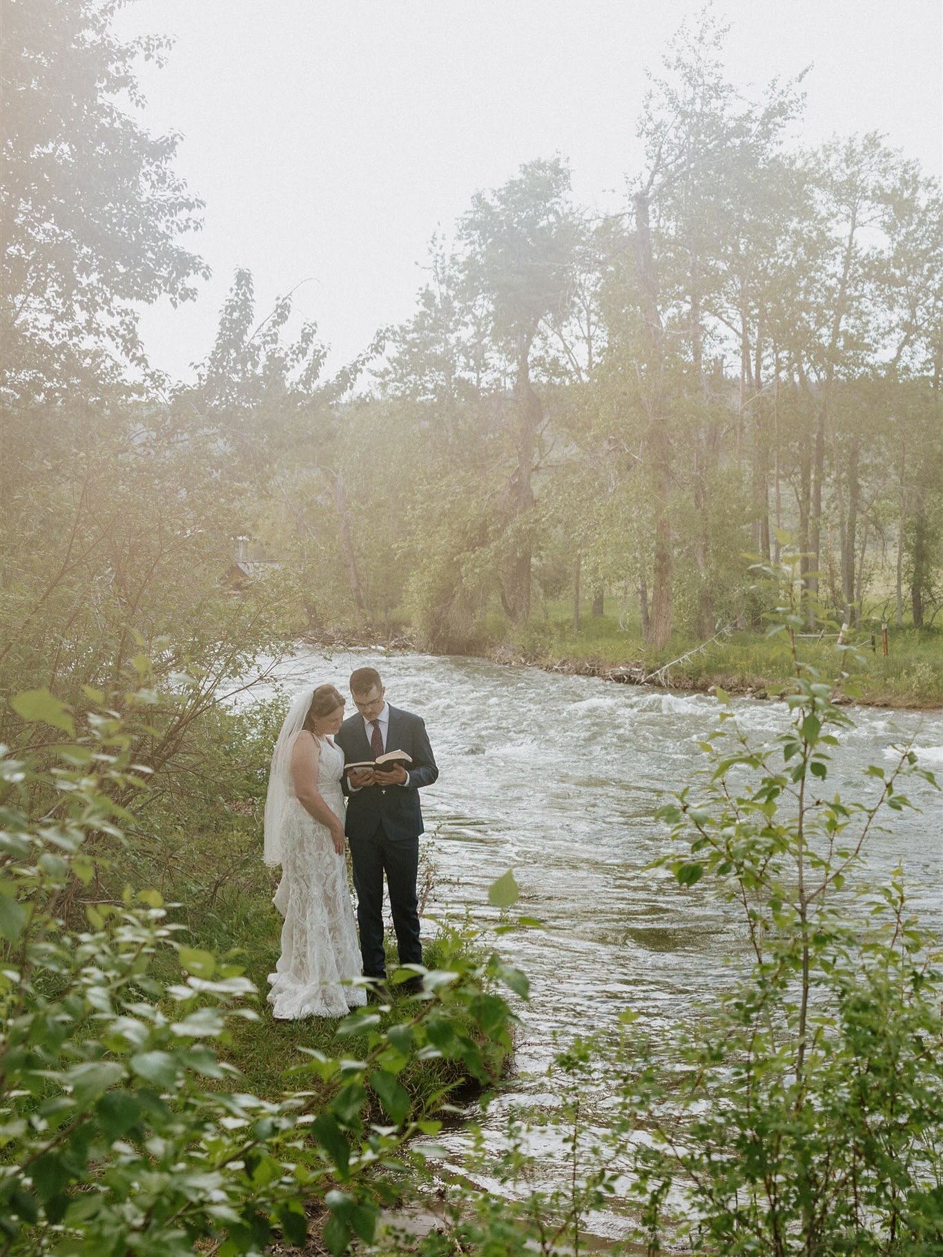 The sweetest river foot washing and private vow reading after their elopement.