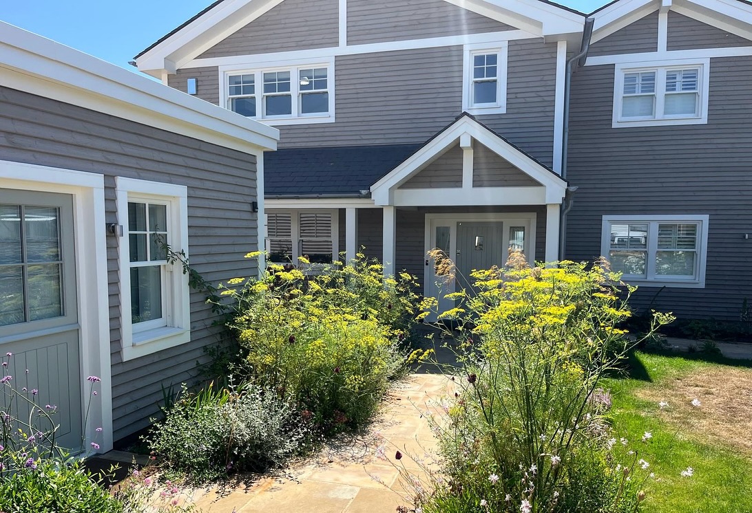 Brand new beach house and brand new garden which has done surprisingly well considering a tough start with no rain and boiling temperatures - photo 3 how’s recycled Brighton pier boards used in decking #brightonpier #beach #coastalhome #seaside #seasideplants #gardendesign #planting #plantingdesign #tuliplandscapeslondon #marine #beachouse #biodiversity #summerplanting