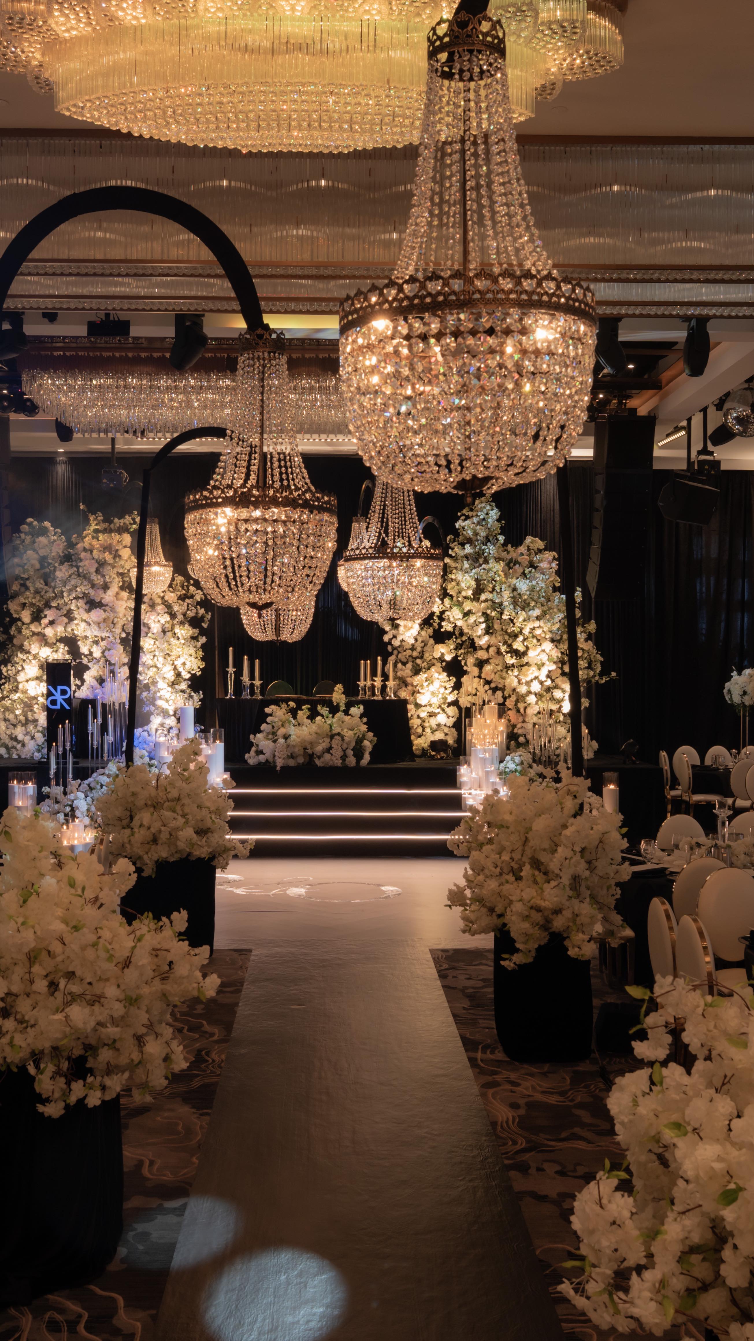 A breathtaking black & White Reception stage adorned with cascading white florals, glowing candlelight, and elegant chandeliers—creating a romantic and luxurious ambiance perfect for a timeless celebration.
Design, Decor and Florals @universaldecor
Venue @reflectionsabby
@caviarcandlescanada @createdbyalliance
@parasrathi
#WeddingReception #WeddingDecor #ReceptionDecor #LuxuryWeddingDecor #WeddingInspiration #WeddingDesign #WeddingStyling #WeddingDetails #WeddingVibes #EventDecor