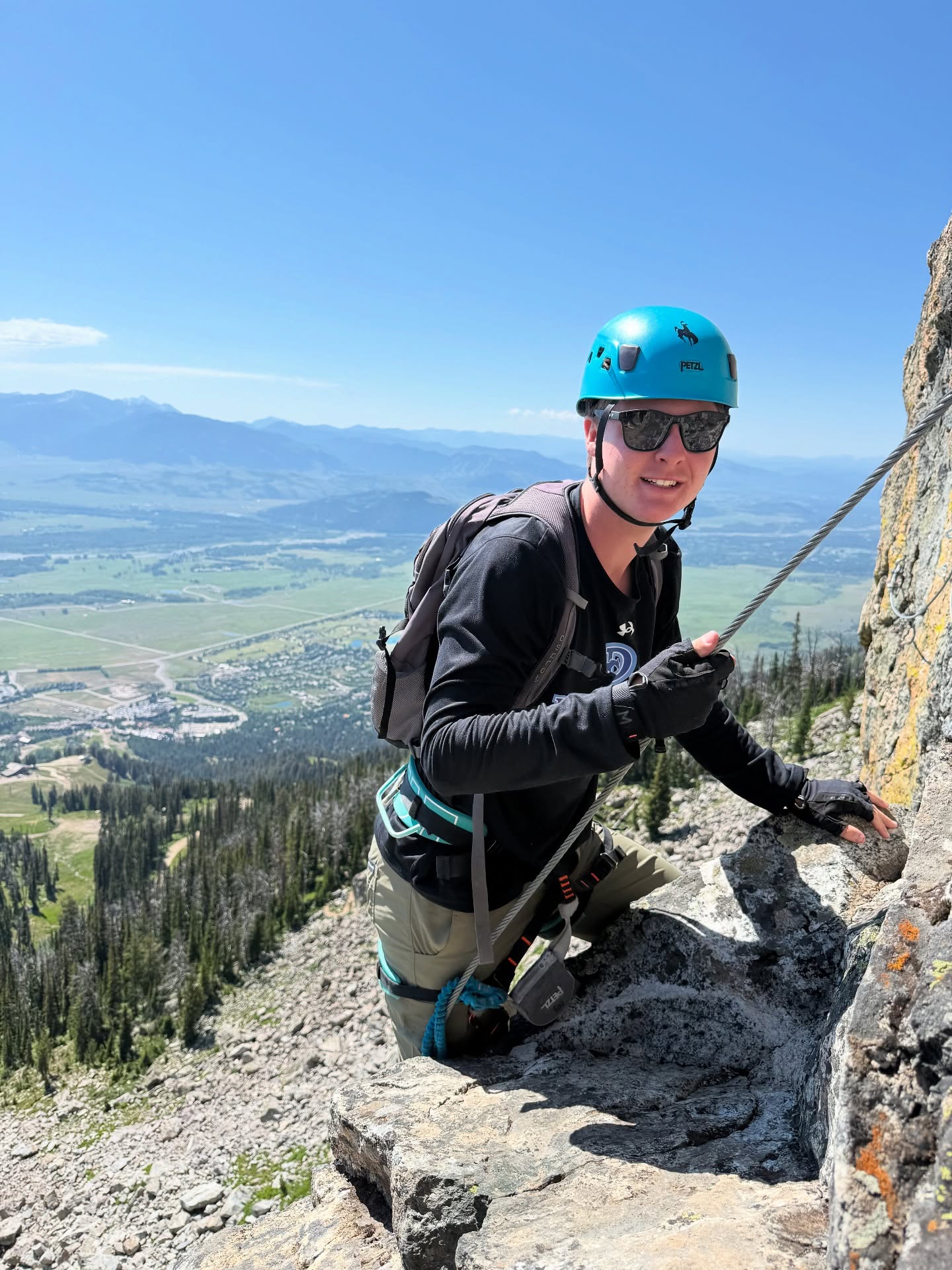 While Aria and I were off hiking Taggart Lake, Randy and Finn spent the day climbing—rock walls and a via ferrata route near Jackson.
They first fell in love with via ferrata last summer in the Dolomites, where you clip into fixed cables and iron rungs bolted into the rock and make your way up exposed routes. In Italy, you just rent the gear and go. Here in Jackson, it’s a bit different—you go with a guide. But the experience? Still amazing.
They got their adrenaline fix and were totally in their element. And the views? The Tetons don’t disappoint.
#viaferrata #rockclimbing #jacksonhole #grandtetonnationalpark #fatherandsonadventures #familytravel #travelwithteens #climbon #rockclimbinglife