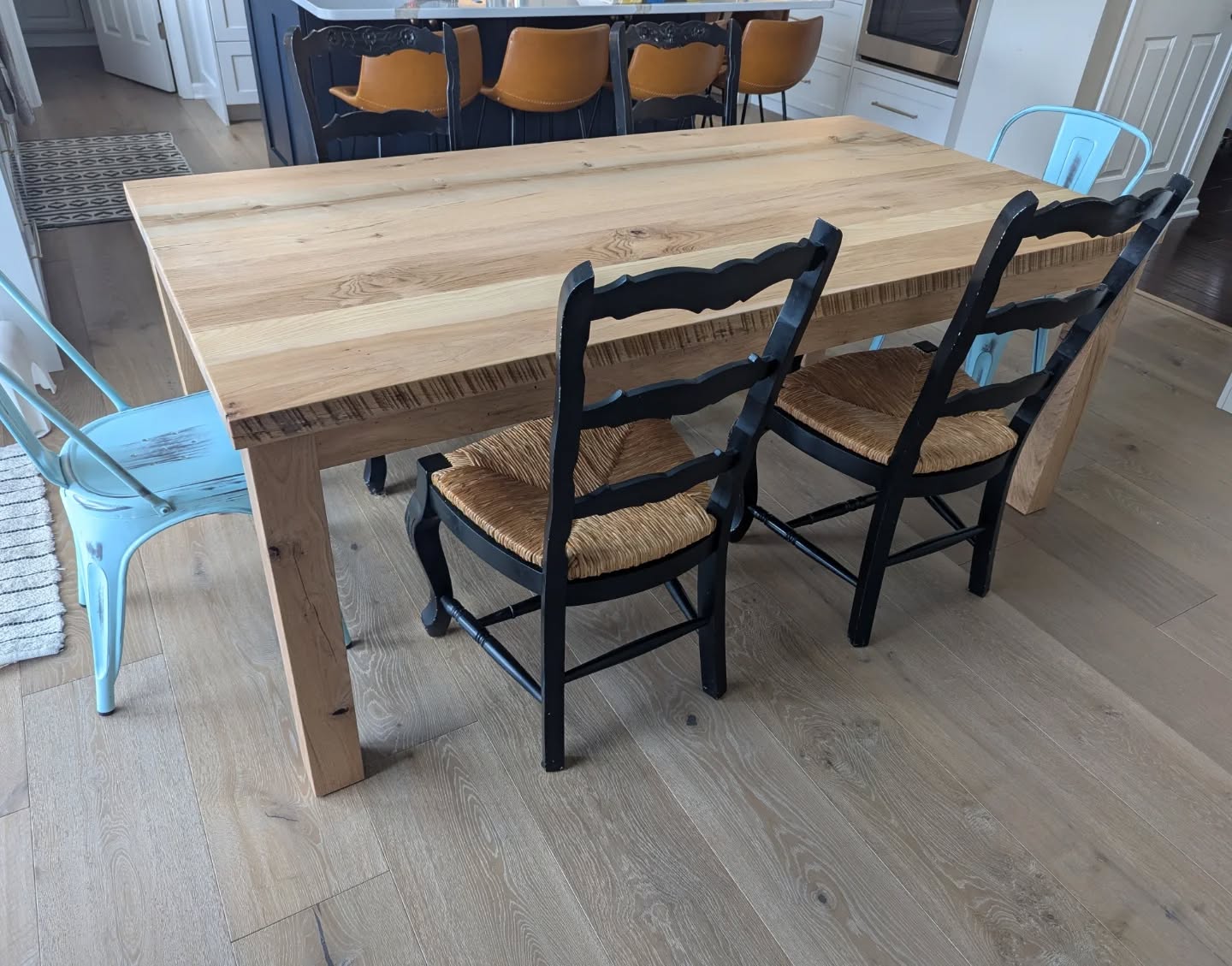 A customer came to us with a rustic trestle farmhouse table they had purchased almost 10 years ago, that was not working for them, only allowing seating on the sides.
We were able to repurpose the rustic reclaimed hardwood top, cutting it apart to surface the boards smooth and create better joints, add to it to make it wider, and build a base that better suited their needs. We paired the top with 3x3 reclaimed oak posts for a twice reclaimed wood parsons style table that now comfortably seats six.
You don't always have to buy new when a piece is no longer working for your needs or space.