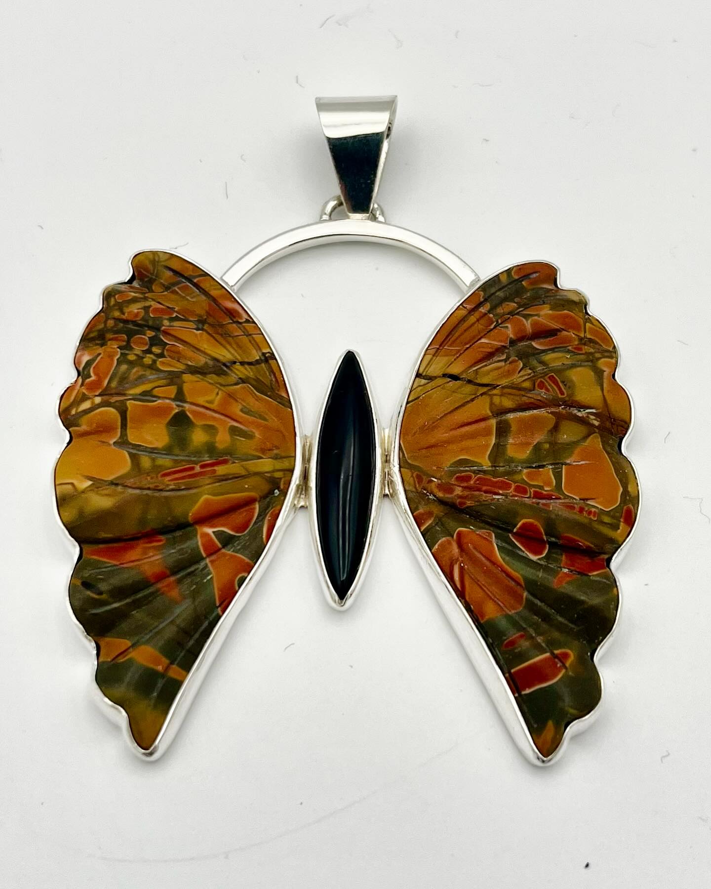 Meet Shadow Flight, a butterfly pendant that embodies transformation and grounding. Crafted with Red Creek Jasper and Black Onyx, this piece is designed for those who seek courage and connection to nature. Explore more: https://wix.to/EeTsJ9H #ShadowFlight #Transformation #HandmadeJewelry
