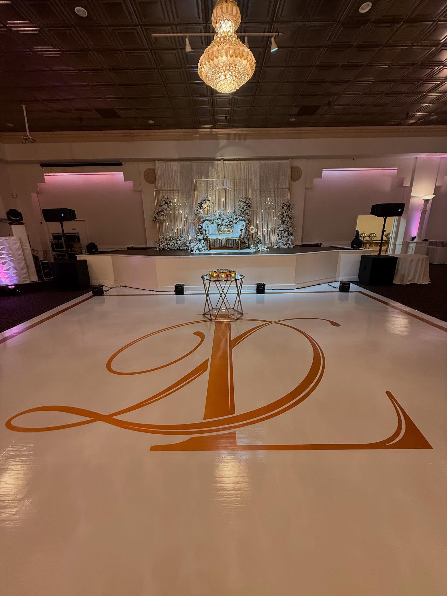 Glossy white wrap with gold initials and boarder at Paradise ballrooms Fremont