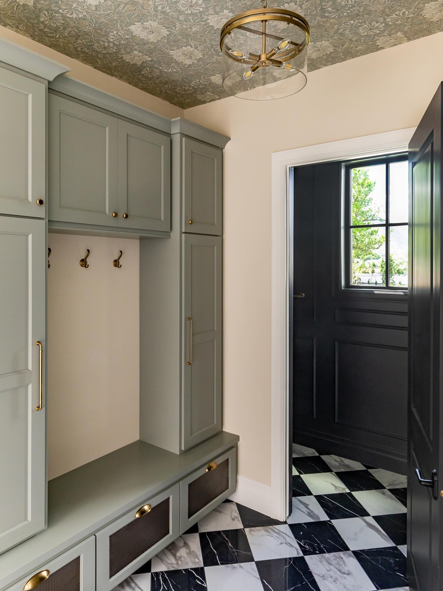 Moody—check.
Wallpaper on the ceiling—check.
Timeless checkered marble floors—check.
This mudroom proves that utility spaces can still be beautiful. We layered rich tones, added unexpected charm overhead, and grounded the space with a classic black-and-white floor that will never go out of style. It’s the kind of entry that makes you want to kick off your shoes and stay awhile.
#InteriorDesign #MudroomDesign #CheckeredFloor #CeilingWallpaper #MoodyInteriors #ClassicDesign #TimelessStyle #EntrywayInspo #mudroom #InteriorGoals #DesignDetails #homeinspo #interiordesigner #interiordesigninspiration