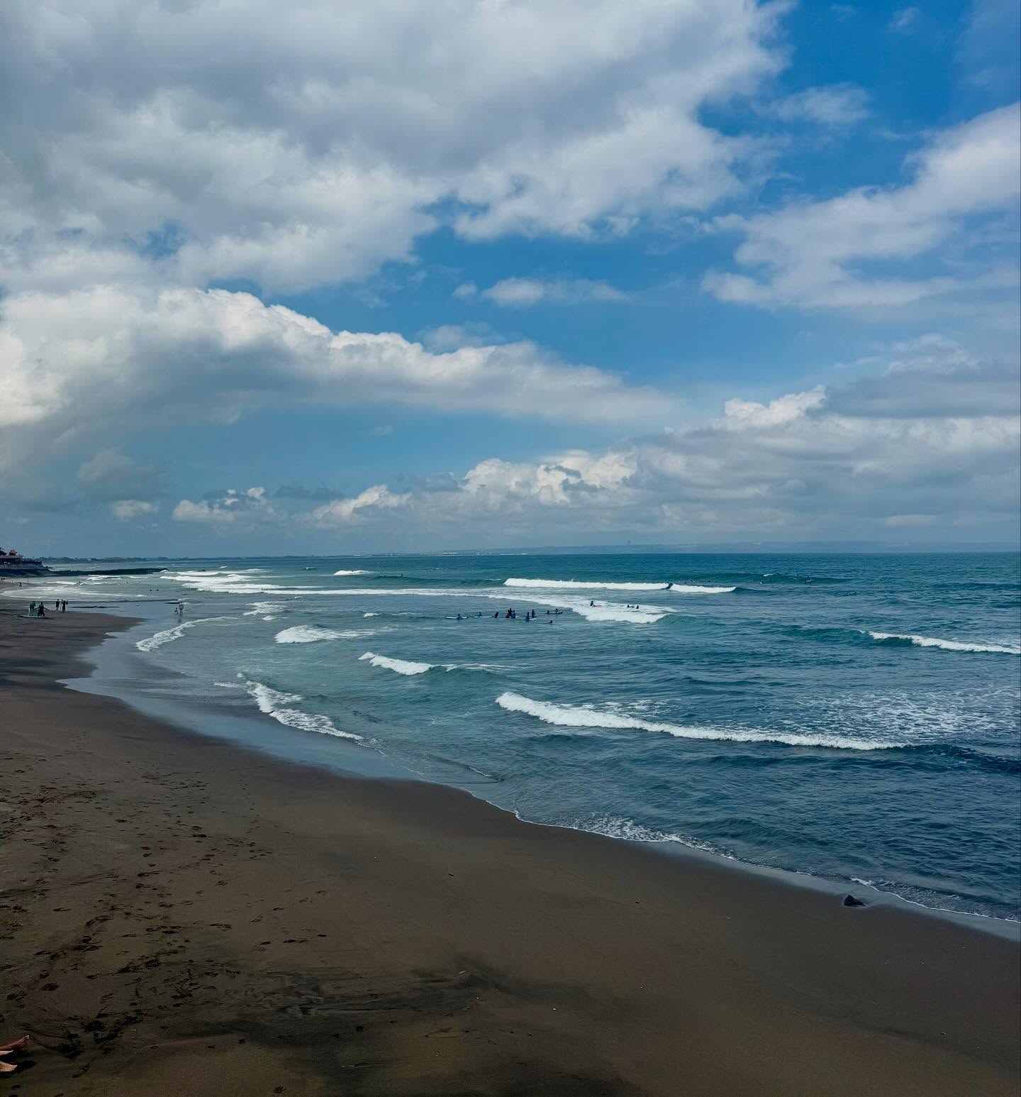 Where the tuk am I?
Standing on a beach that looks like it’s been through the printer on grayscale mode. Black sand. Blacker coffee. Linen so white it’s practically smug.
Cue the barefoot surfer dudes weaving between scooters like spiritual Mario Kart.
Someone’s meditating. Someone’s filming their dog.
And me? Just trying not to get volcanic sand in my tailored Hoi An pants.
Welcome to Pererenan — the monochrome cousin of Bali’s beach scene.
#WhereTheTukAmI #LinenPantsAndLifeCrisis #VolcanicVibesOnly