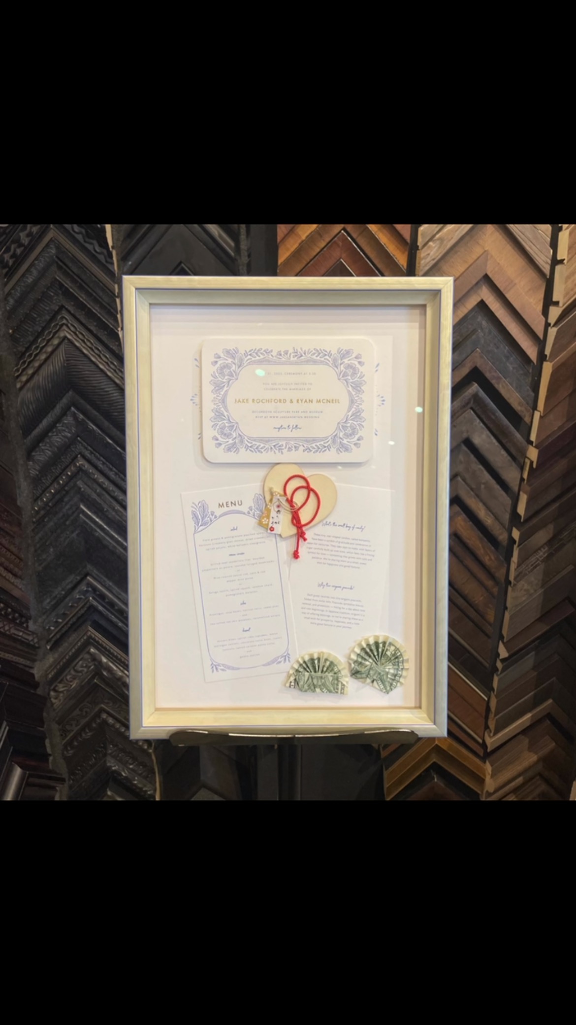 Framing their wedding invitation as a gift is so awesome! We recommend collecting a few things from the celebration to incorporate into this thoughtful and unique present. Swing by for some great ideas! #weddinginvitation #shadowbox #uniquegift #oneofakind #weddinggiftideas #customartframing #handmade