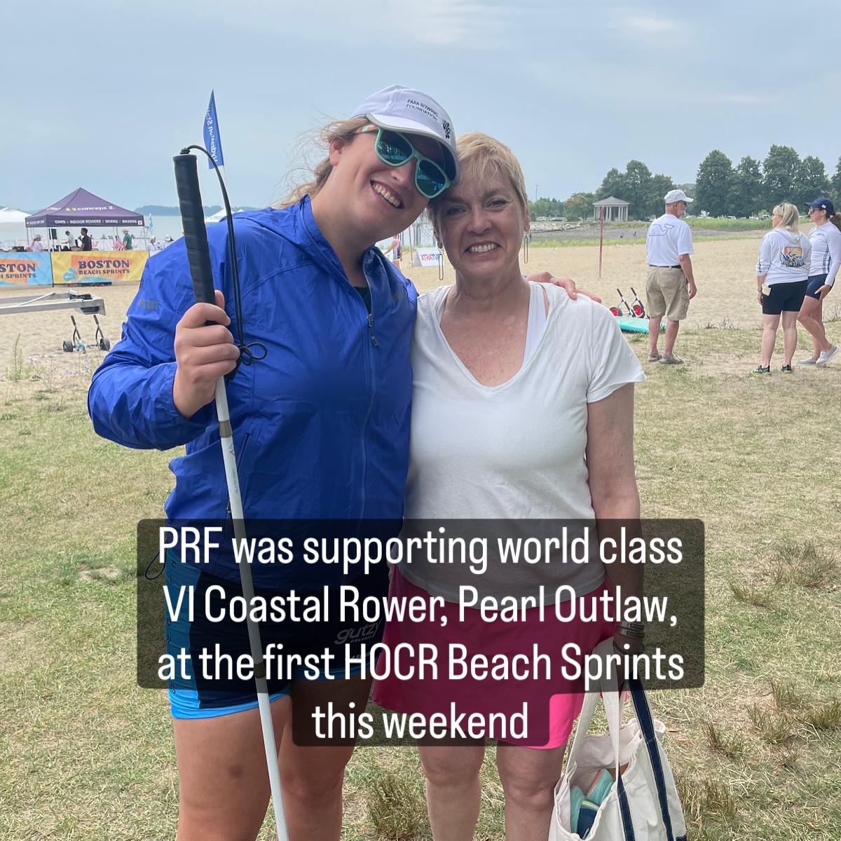 At HOCR Beach Sprints, the weather wasn’t great but it didn’t dampen #pararowing spirits! #SmashingIt
(😎 spot the PRF cap!)
#everyBODYrowing
Alt: Pearl Outlaw is an American VI rower. She stands on the left of the picture holding her white cane, wearing a blue lightweight rain jacket over a light and dark blue uni suit, green sunshades and a white PRF cap. Next to her is Marilyn Koblan, cofounder of PRF. She has short blonde hair, wears a white tee and a bright pink skirt, and is holding a white tote bag. Both smile directly at the camera.
