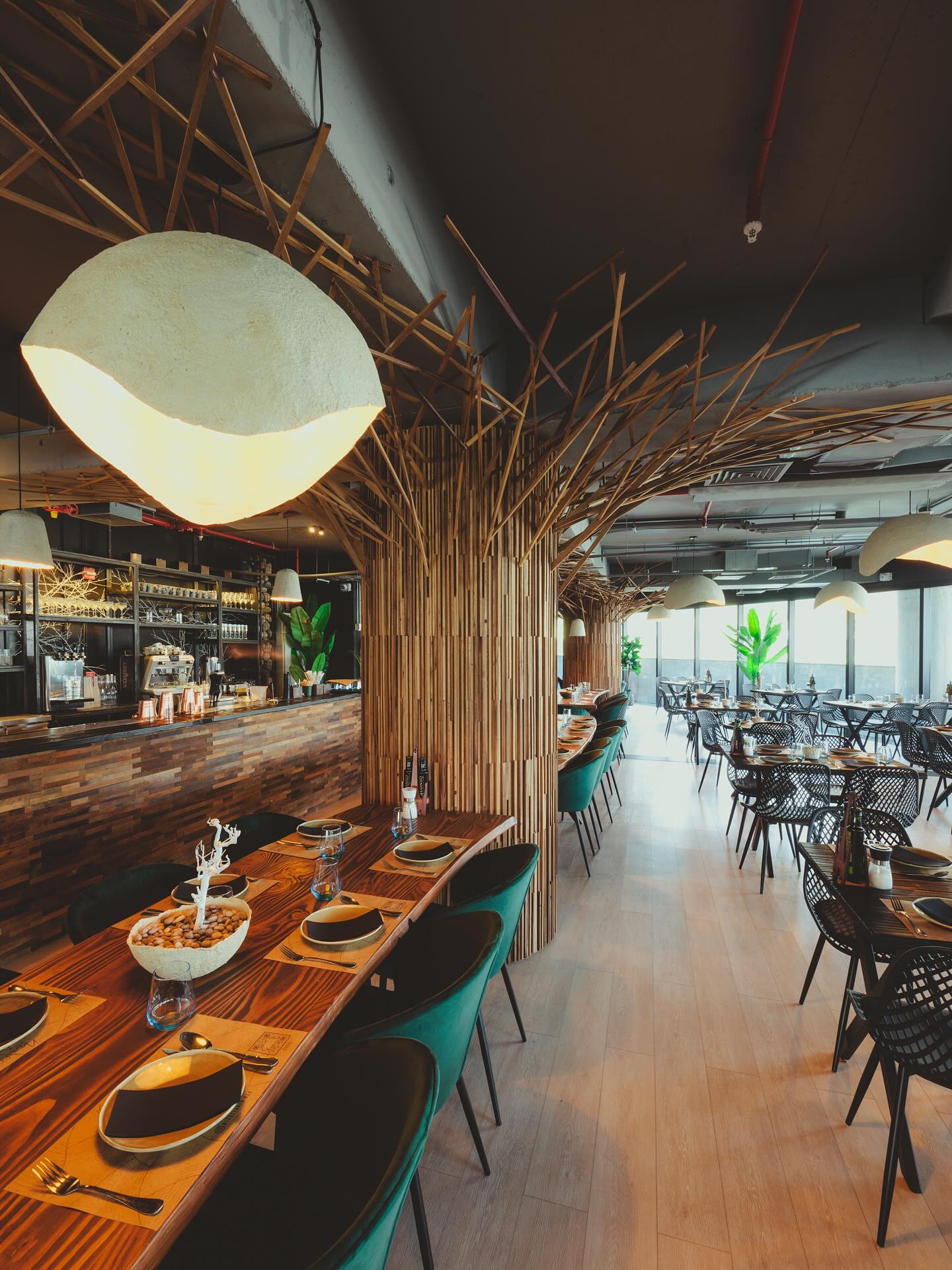 En @miscelaneo.bar desarrollamos una instalación escultórica que define el carácter del espacio y articula su atmósfera. El encargo: diseñar un gesto hecho a mano, que dialogara con la cocina de @miscelaneo.bar —auténtica, honesta, artesanal— y construyera una experiencia coherente desde lo material y lo espacial.
Trabajamos con duelas recuperadas de la industria vitivinícola, procesadas junto al CET de Valparaíso y @reviste_chile en un proceso de reinserción social. Con esas piezas diseñamos un revestimiento de tres anchos (3,5 / 2,5 / 1,5 cm) y tres profundidades, que evitara repeticiones visuales y pudiera parecer orgánico, pero ser constructivamente claro.
El patrón fue cuidadosamente diseñado para que la instalación se viera como una corteza viva: ordenada, pero impredecible. Creamos una matriz que nos permitió entregar instrucciones precisas de montaje al equipo en terreno, manteniendo esa apariencia natural.
Desde ese revestimiento base, la intervención evoluciona en ramas que se elevan con distintos grados de giro y torsión. El gesto se expande por el cielo del restaurante hasta encontrarse con los árboles reales del salón, uniendo materialidad y atmósfera en un solo sistema.
El resultado: un artefacto espacial que organiza el lugar, define su identidad y proyecta el relato del restaurante a través del diseño.
Este proyecto fue desarrollado en colaboración con @lenka.estudio, quienes invitaron a @pizarrastudio a participar con esta instalación artística, el revestimiento de la barra y el cielo de los baños.
Ponle #estrategia
Ponle #creatividad
Y una cuota de #arte
Si quieres saber más del proceso creativo de este y otros artísticos proyectos de restaurantes, te invitamos a visitar el sitio web de @pizarrastudio 🤓Link en la bio!
#RestaurantDesign #BarDesign #HospitalityDesign #RestauranteChileno #DiseñoRestaurantes #RetailDesign #ExperientialDesign #BrandingEspacial #DiseñoConIdentidad #DiseñoSensorial #diseñoespacio #decoracion #diseñodeinteriores