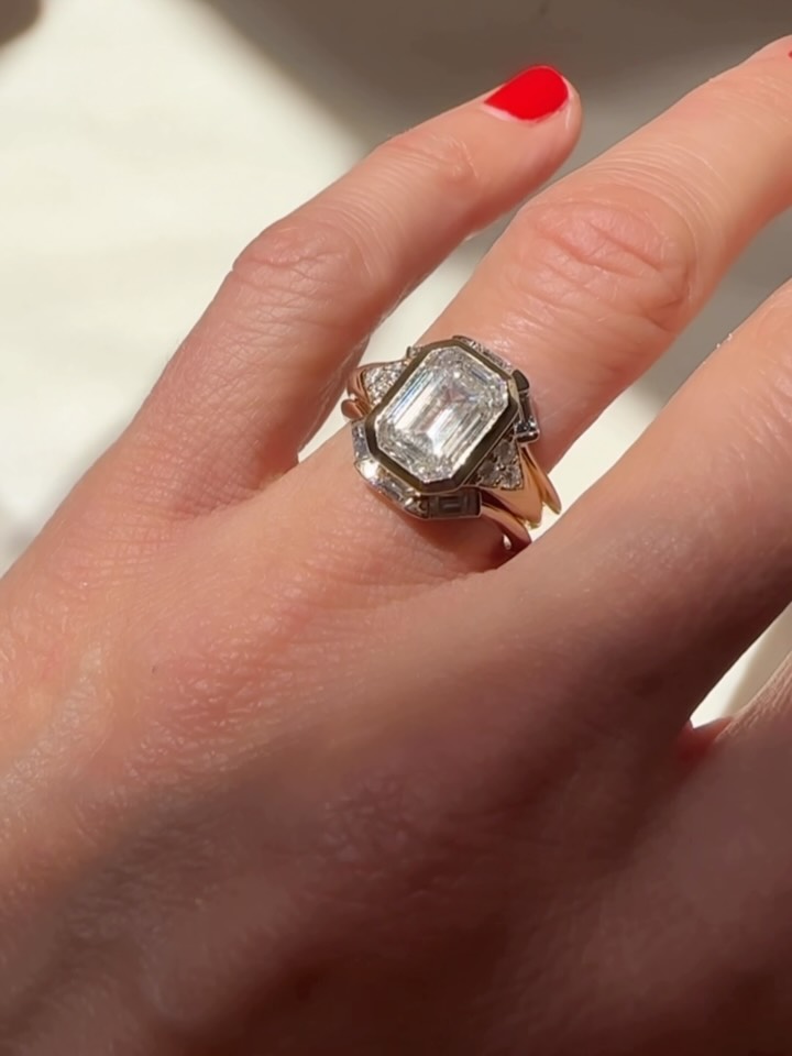 She’s Italian, he’s Peruvian. Two cultures coming together in love and fitting together perfectly. ✨ With him I created the engagement ring - a beautiful stunner of a diamond center emerald cut diamond framed by tiny pave set diamonds. A knife edge shaped band gives it a cool shape that’s a more cool and modern look. He knew just what she liked. With her we designed a ring guard or ring enhancer style wedding band. Although the engagement ring needed no enhancement 🤪 this band came together seamlessly. Sorting through the styles that she loved, we used these near flawless baguette cut diamonds to frame and hug the center stone. A perfect set like a talisman of their love where two people fit together like a puzzle. Ain’t love a beautiful thing. ❤️🤘🏽 #katherinelincoln#madeinnyc#nyc#bespokewedding#customjewelry#sculturaljewelry#goldsmith#engagementset#ringguard