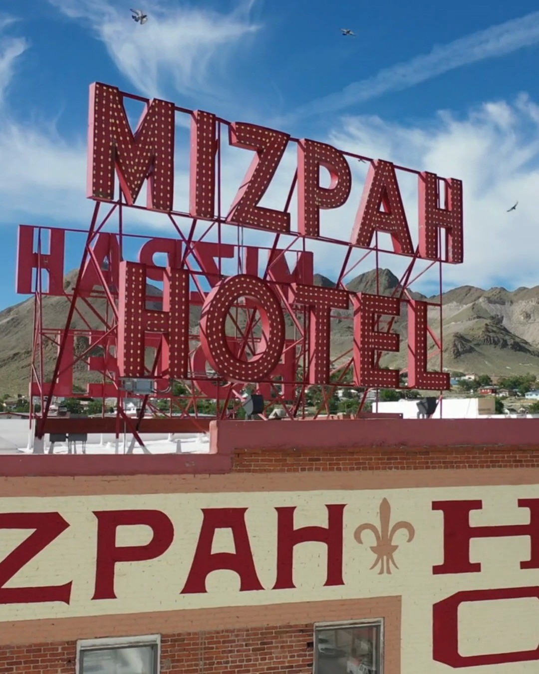 Perched high above Tonopah, the glowing red letters of the Mizpah Hotel have welcomed travelers for over a century.
This view says it all — iconic, bold, and rooted in history. Whether you're road-tripping through Nevada or looking for a destination with character, the Mizpah is more than a stay. It's a story.
Sleep in history. Wake up inspired.
#MizpahHotel #HistoricNevada #VisitTonopah #TravelNevada #NevadaLandmarks #DroneNevada #WesternHeritage #IconicHotels #ExploreNevada #TonopahHistory #NevadaViews #StayLegendary