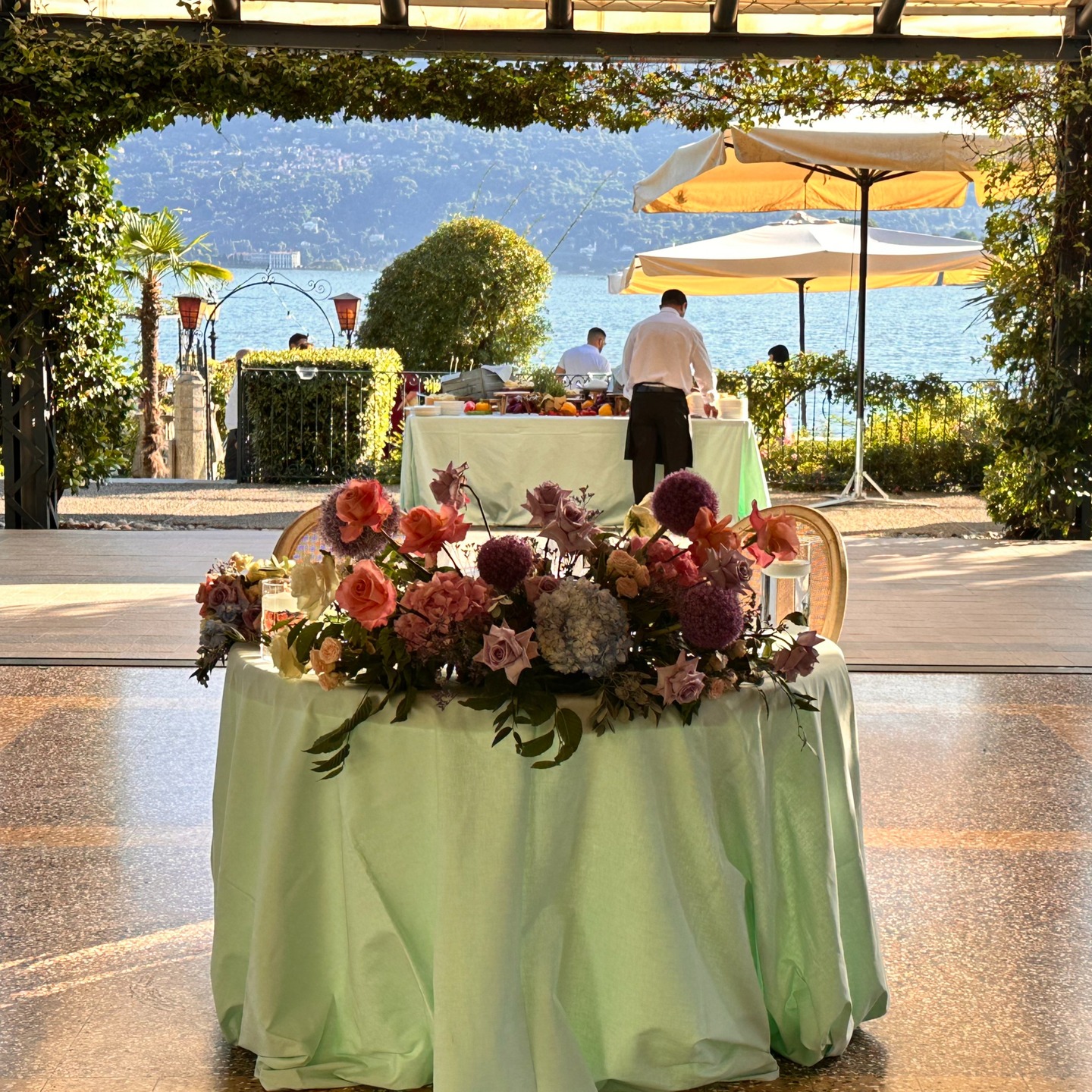 .
Soft pastel green linens set the tone for an atmosphere of refined elegance, while vibrant, towering floral centerpieces added a bold and joyful splash of color to the room.
Every table told a story of beauty, balance, and celebration — a perfect harmony between sophistication and playfulness for Marina & Jachim.
A truly unforgettable setting for an unforgettable night. 🌿🌸🥂
Catering: @tamilano.catering
Flowers: @lavieenrosearona
Chairs: @luxury_noleggio
#LakeMaggioreWedding #WeddingReceptionInspo #ElegantWedding #ColorfulCenterpieces #PastelWedding #ItalianWeddingStyle #WeddingPlannerItaly #DestinationWeddingDecor