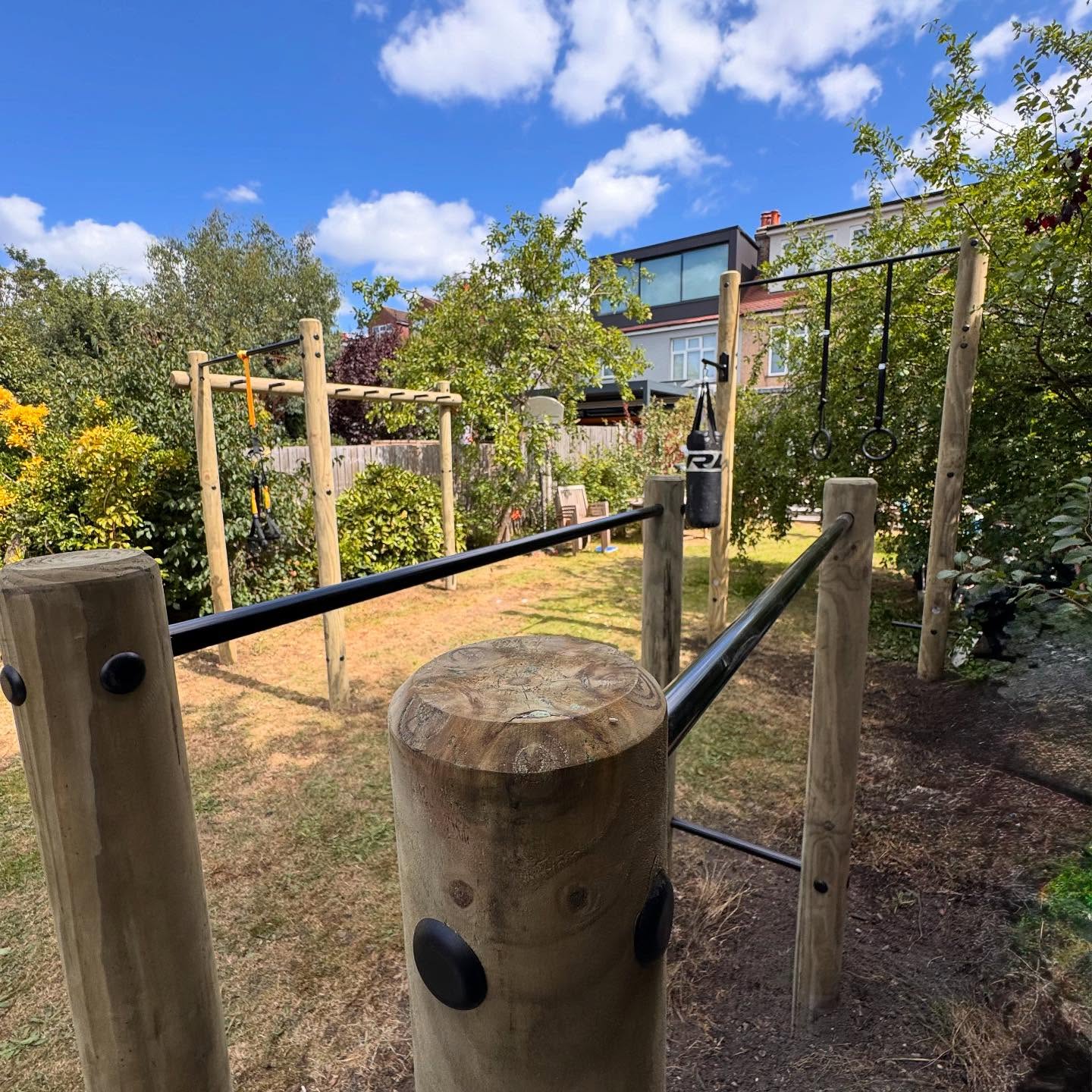 Brilliant installation of a multi rig gym. Monkey bars and pull up, separate dip station and a 2.9m high pull up bar with a boxing bag bracket. Rings, steps and a suspension trainer to finish it off. #gardengym #pullupbar #pullups #dipstation #outdoortraining