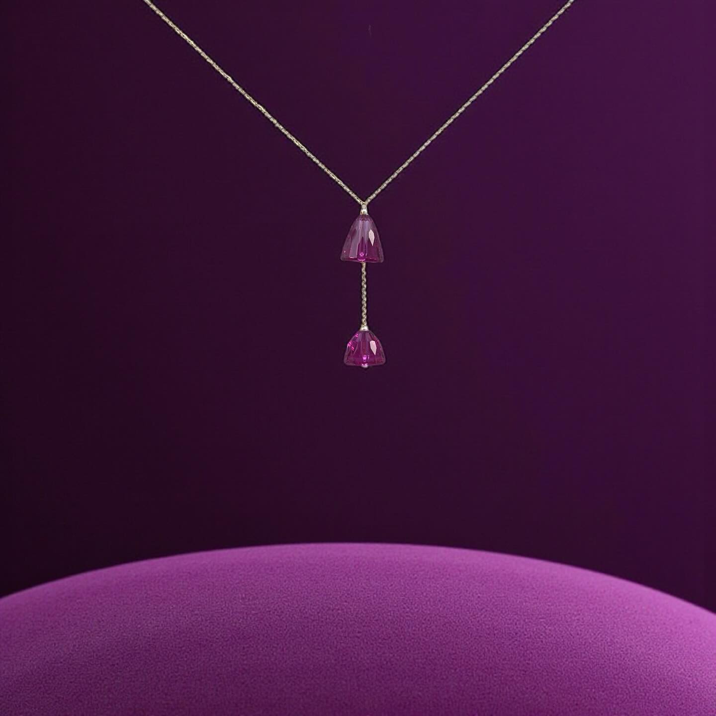The Prism Bell Lariat:
A delicate cascade of light, this unique lariat necklace features a beautiful two-piece design that is both elegant and romantic. The gold-toned chain supports a stunning drop of two faceted, bell-shaped crystals. With one crystal at the end of the lariat and the other positioned slightly higher, the necklace creates a dynamic and graceful visual. The polished facets allow the crystals to beautifully catch and reflect light, adding a touch of sophisticated sparkle to your look.