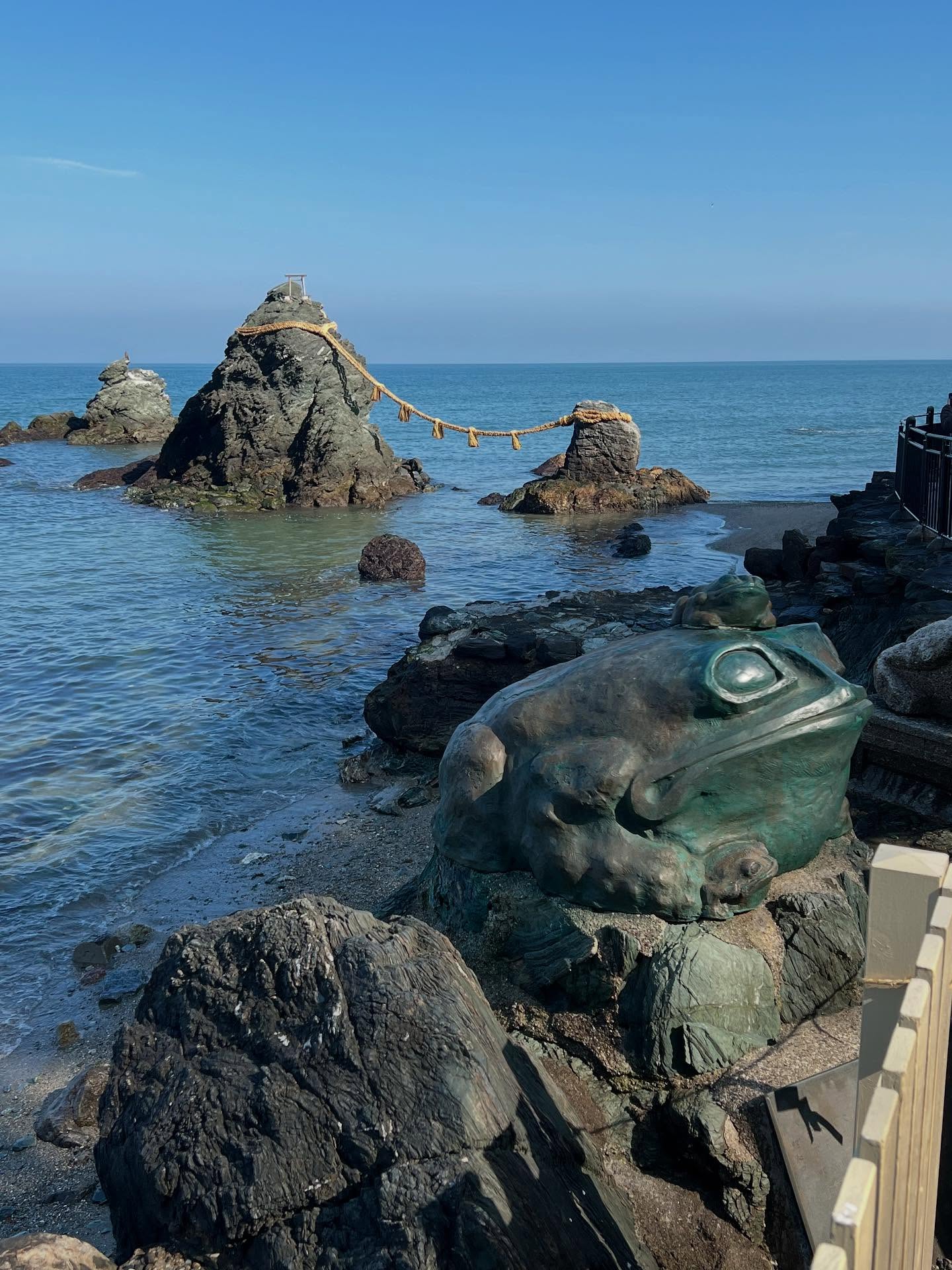 Offshore in Futami-ura you’ll find the Futami Meoto Iwa Rocks, a large and a small sea stack bound together with straw ropes. They’re said to represent and celebrate the union of a married couple. Newlyweds visit to endorse their marital bliss and singletons to pray for good luck in matchmaking. The Futami Okitama Shrine is close by and the walkway by the ocean is a popular spot to stroll. It’s decorated with frog sculptures, believed to be charms that return people or things back into your life.
#iseshima #japan2025 #japan2025🇯🇵❄️ #travelwriter #traveljournalist #futami #frogshrine #japanesephotography #japantoday