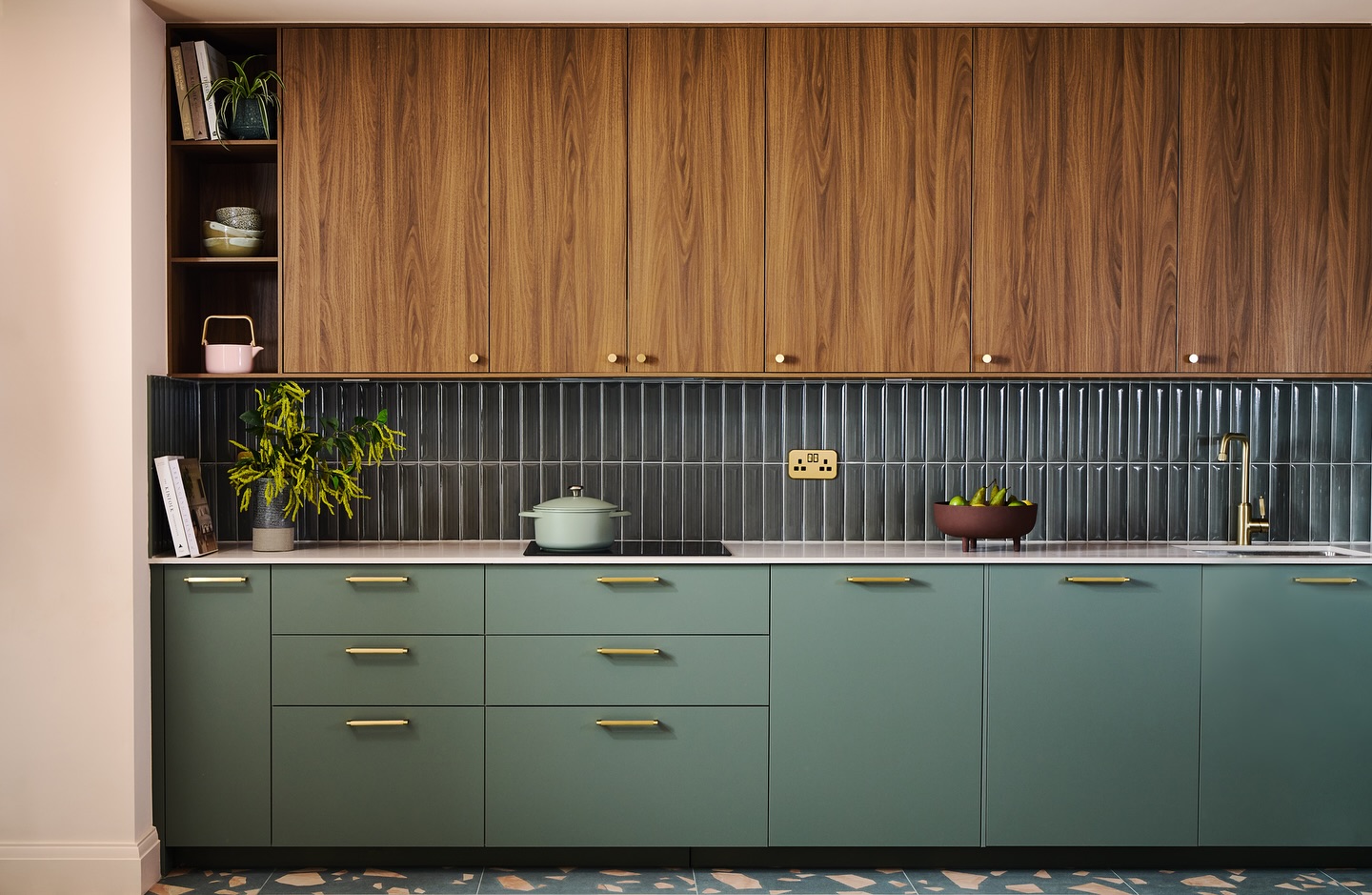 FIRST LOOK AT THE KITCHEN from our London flats development project
Love this open-plan space. The darker tones and patterned floor tiles subtly zone the kitchen area, giving the space definition while still feeling connected to the living space.
We chose a considered mix of materials – from higher-end tiles and detailed brass hardware to more cost-conscious cabinetry – to strike the balance between a developer’s budget and a higher-end look, steering well clear of bland.
A warm, contemporary palette of clean lines, walnut wood, muted green and touches of brass ties the kitchen into the open-plan reception, with colours and shapes that flow throughout the apartment.
It may be a landscape shot (and yes, Instagram isn’t always kind to those!) but I couldn’t resist sharing this one. ❤️
>> Swipe for the un-styled work-in-progress shots – from bleak to bliss once the sunlight came streaming in. Each floor has its own little twist or layout variation to keep things interesting.
Interior design & styling @andthentheywentwild
Photography @still_loljohnsonphotography
London kitchen design, open plan kitchen, development project, show home, home staging, modern apartment kitchen, kitchen zoning ideas, walnut kitchen cabinets, green kitchen cabinets, brass kitchen hardware, kitchen styling ideas, kitchen colour palette, new build kitchen design, developer show home design, contemporary kitchen ideas