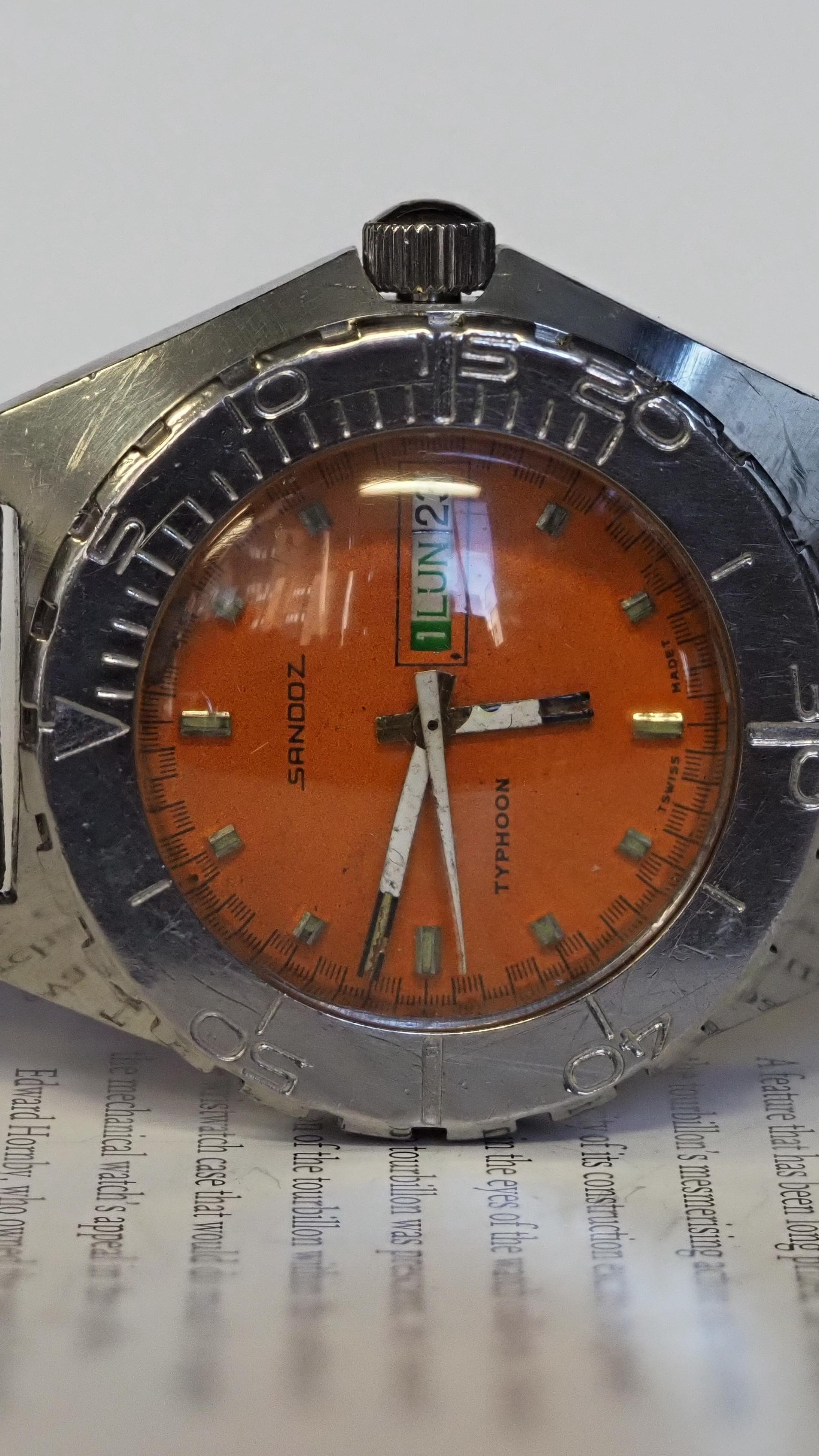 Don’t forget that the watches you see on YouTube, TikTok, and from most dealers are just the tip of the iceberg.
Personally, I love finding the other pieces you rarely see, that still turn heads, and that stay under $5K–$6K CAD.
Case in point: the elusive Orange Dial Sandoz Typhoon.
A thousand-meter-rated diver with a massive domed plexiglass crystal. From the front it looks great, but from the side you see decades of history etched into the crazing. IMO These are the kinds of finds that make collecting exciting.
#watchcollector #watchcommunity #watchoftheday #luxurywatches #watchenthusiast #horology #mtl #watchaddict #yul #514
