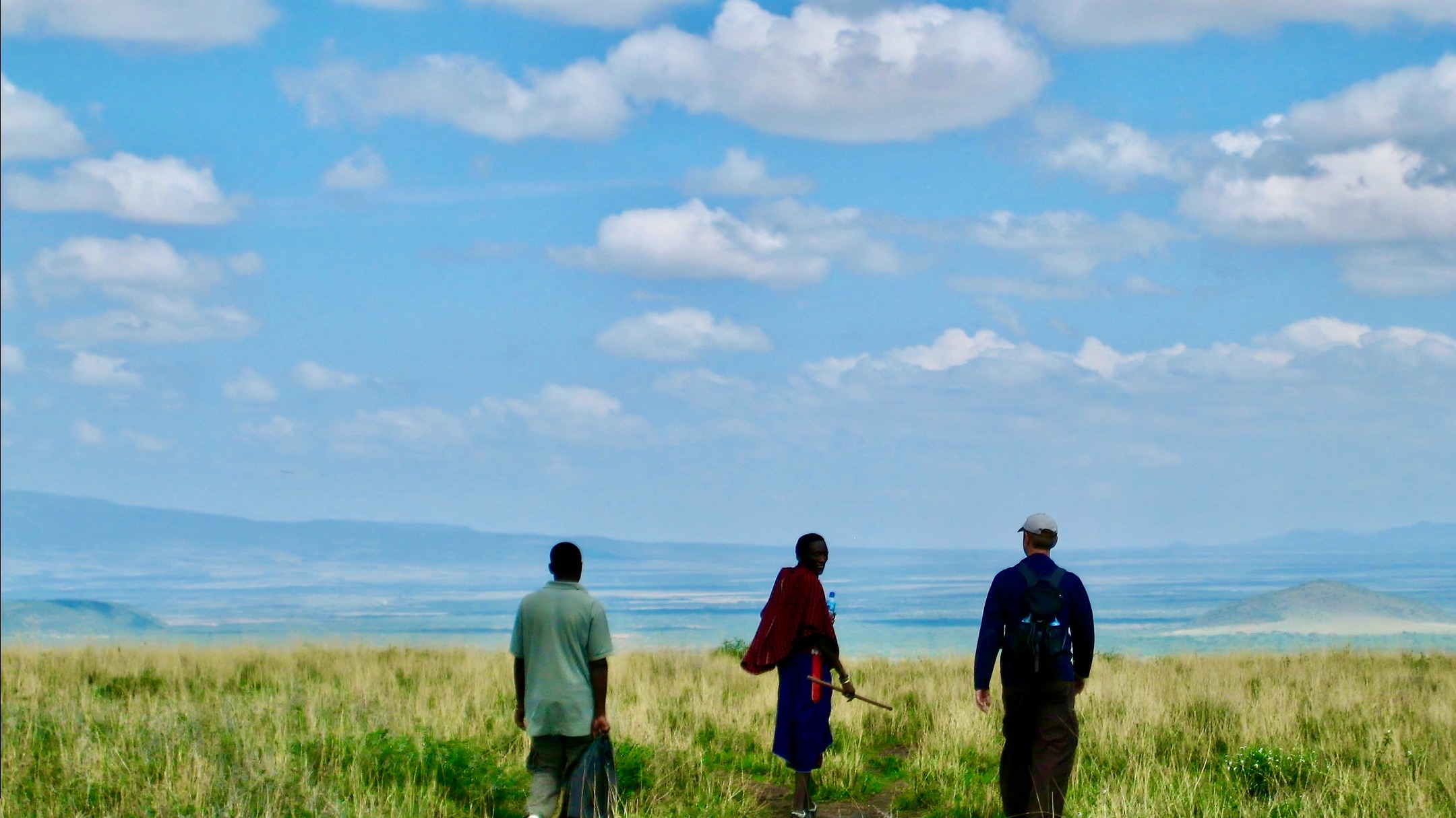 Trek through the vast Rift Valley that spreads out in dusty tones of grey, brown and yellow. Within this vast, dry landscape, the Maasai bomas (enclosures) are barely distinguishable and sparsely strewn. In each boma there are a number of huts; each hut is the home to one of the wives of the Village Chief, a Maasai Warrior.