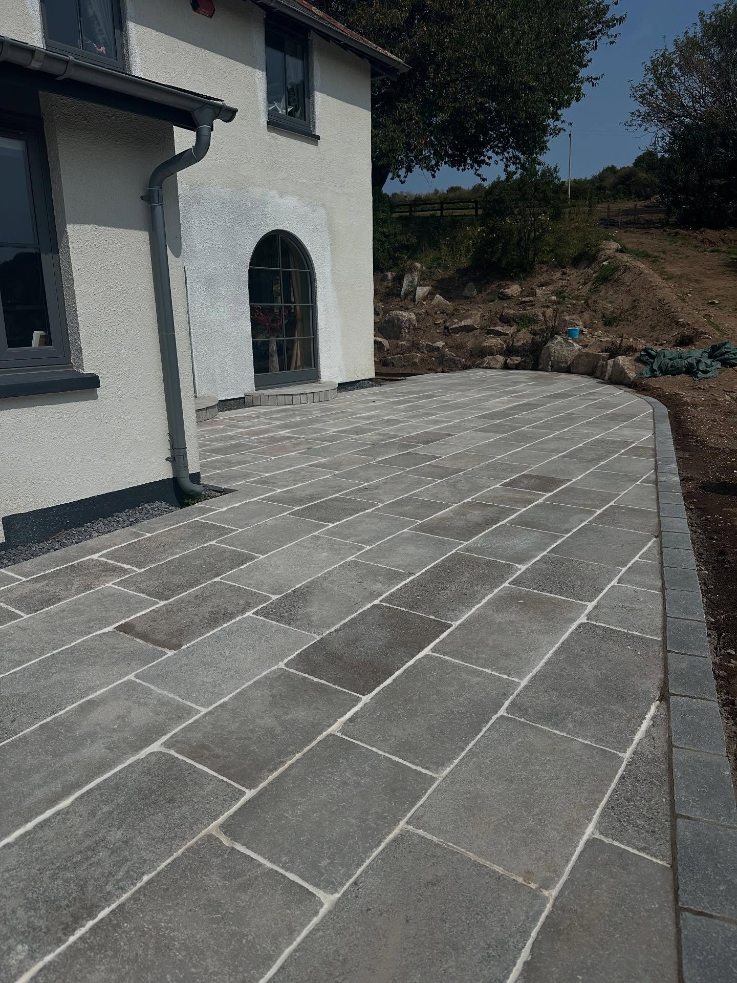 Final stages! We're adding the finishing touches to the hard landscaping on this one. Featuring 200sqm of limestone from @quornstoneofficial and corten steps from @dingleforge_devon. The garden's design was built around encapsulating Dartmoor, so we have used huge pieces of Granite as our retaining walls, used traditional Devon banks and dry stone walls and will be using naturalistic plant design to tie everything together #chagford #gardendesign #landscaping