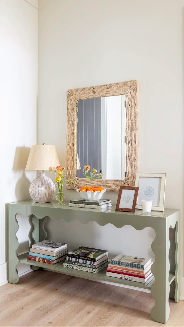 The entryway is the first impression of your home - it should feel fabulous!! ✨ We took the greens from the kitchen of this project and tied them in with this custom entryway console. Adding custom furniture to your home is the perfect way to make it feel completely unique to you. As interior designers, we always aim to have a few custom pieces in every home for this reason! 😍
The natural materials of the mirror and the basket lamp made the green even more of a statement & of course, you can never have too many decorative books! 👏🏼
As interior designers on Kiawah Island, we always make sure to tie in natural materials with fun colors. Reminding you that being at the beach can still be glamorous 🎉