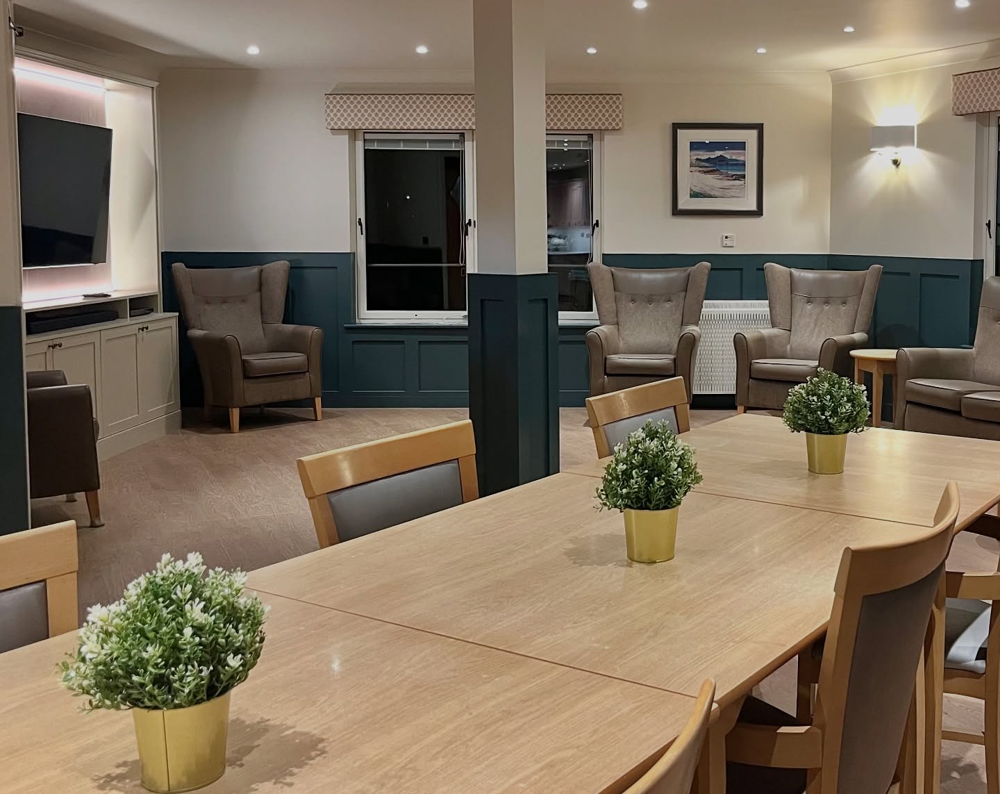 One of my most rewarding projects this year has been working with a local care home in Dundee. We have been updating the interior over the last few months on floors 1,2 and 3.
Moving away from the existing grey colour palette, we have given each floor its own unique colour combination. These photos show the before and after shots of floor 2, using a rich, dark blue colour on the new wall panelling, patterned pelmets above the windows, and a pop of pink with the new kitchen cabinets. Plus some pretty new floral art prints.
My hope is that the bright new interior will promote a sense of wellbeing for the residents. There is still work to be done, but I, along with the owners, are keen to create a home from home experience. For these residents, in the latter stages of life, we hope to provide an environment that is calm, comfortable, timeless and beautiful.