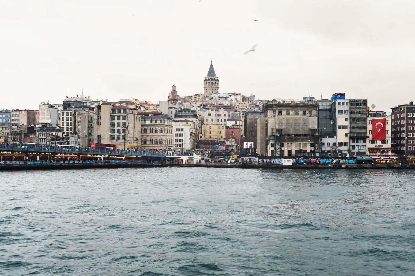 Across the shimmering waters of the Golden Horn, the Galata Tower rises proudly above Istanbul’s skyline, a timeless sentinel of the city. The bridge stretches across the river below, buzzing with life, while the tower keeps watch as it has for centuries, blending the pulse of modern Istanbul with echoes of its storied past.
#GalataTower #GalataKulesi #IstanbulViews #GoldenHorn #GalataBridge #IstanbulSkyline #VisitIstanbul #TurkeyTravel #HistoricLandmarks #TimelessViews #CityscapePhotography #TravelInspiration #EpicViews