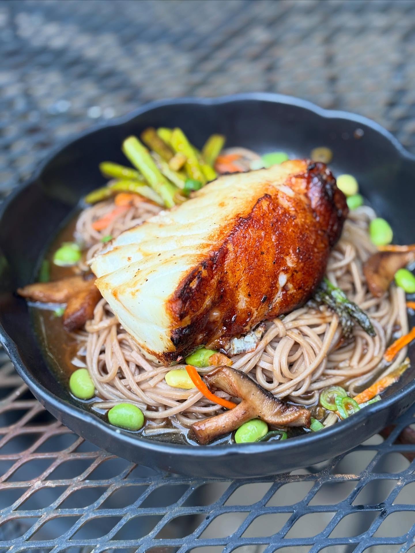 Chilean sea bass from @saltwater_markets glazed with ponzu miso sauce, served over soba noodles and asparagus with shitake miso broth