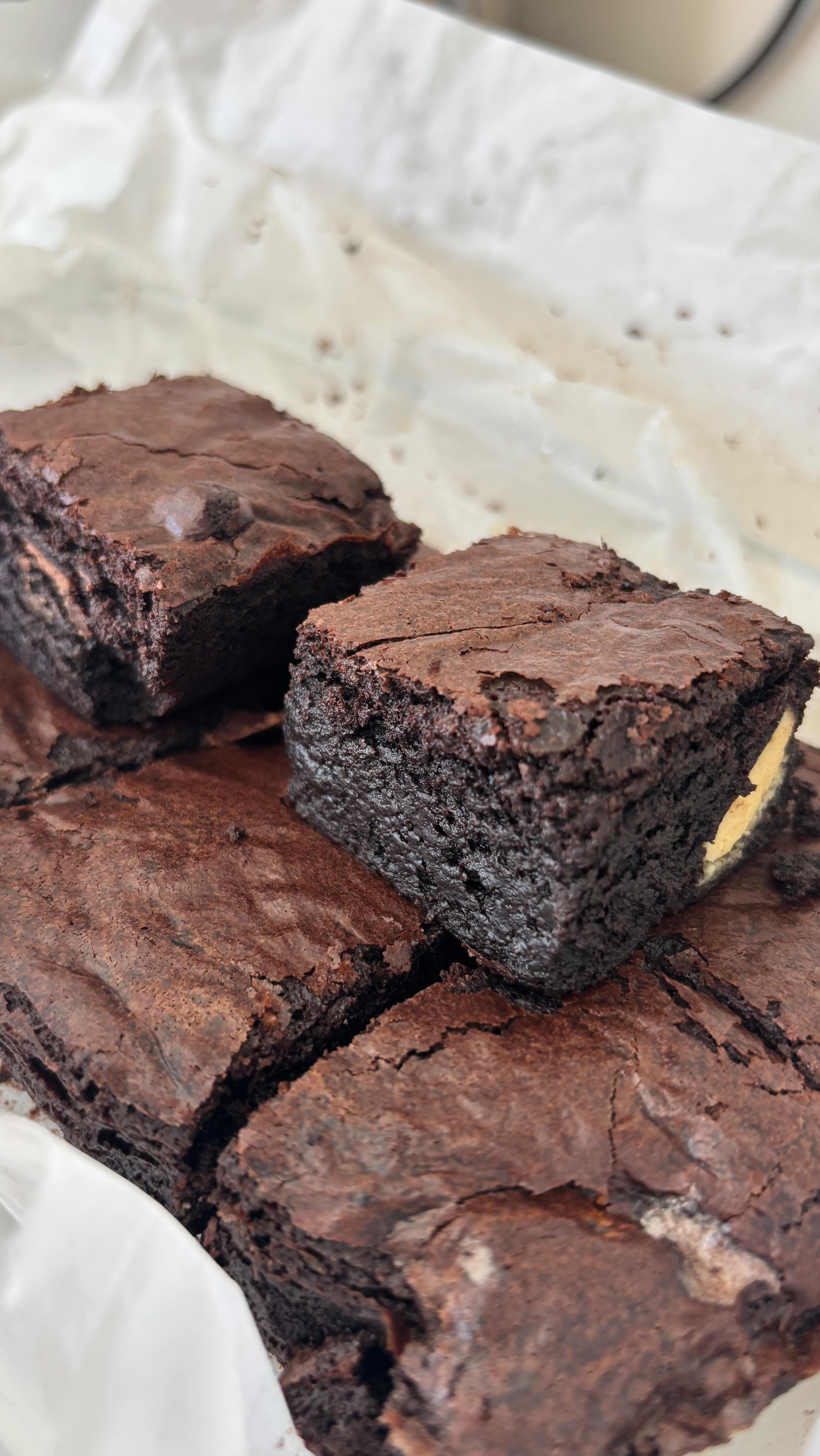 Ingredients
185 gr. unsulted butter
185 gr. good quality dark chocolate
3 large eggs
275 gr. golden caster sugar
40 gr. cocoa powder
50 gr. milk chocolate
50 gr. white chocolate
85 gr. plain flour
Instructions
Grease and line a 20cm square baking tin with parchment paper. Cut the butter into pieces and place it in a heatproof bowl along with the dark chocolate, broken into chunks.
Melt the butter and chocolate together in the microwave, stirring every 30 seconds until smooth and fully combined. Mix well until the butter is completely incorporated into the chocolate, then set aside to cool.
Break the eggs into a large bowl, add the sugar, and whisk until the mixture becomes pale, creamy and has roughly doubled in volume.
Gently fold the cooled chocolate mixture into the egg mixture. Sift the cocoa powder and flour over the batter, then carefully fold them in until fully incorporated.
Stir in the white and milk chocolate chunks, breaking them into small pieces before adding them to the batter. Pour the mixture into the prepared baking tin and bake in a preheated oven at 180°C (356°F) for about 35 minutes.
TIP: Let the brownies cool completely before cutting them into squares for the best texture. #Brownies #FudgyBrownies #ChewyBrownies #HomemadeBrownies #ChocolateDessert #ChocolateLovers #BrownieHeaven #ChocolateAddict #BakingFromScratch #HomeBakers #BakersOfInstagram #InTheKitchen #FoodPhotography #FoodieDelight #BakeAndShare #Foodstagram #DessertPorn #SweetTooth #FoodieLife #YummyInMyTummy #BakingLove #ChocolateFix #FoodieForLife #HomeCooks #EasyRecipes #SweetEats#